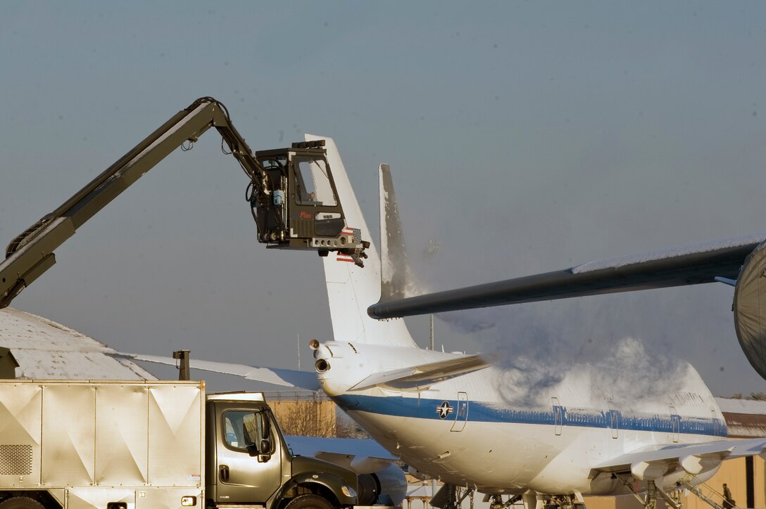Members of the 316th Civil Engineer Squadron snow removal team de-ice a C-17 Globemaster from the 452nd Air Mobility Wing, March Air Reserve Base, Calif., Jan 8 on Joint Base Andrews. Team Andrews members spent most of the morning de-iceing aircraft and clearing the flightline of snow and ice after a storm brought approximately one to two inches of snow to the area. The snow removal team helped to ensure the efficient takeoffs and landings of all inbound and outbound aircraft on the Joint Base Andrews flight line. (U.S. Air Force photo by Airman 1st Class Perry Aston)