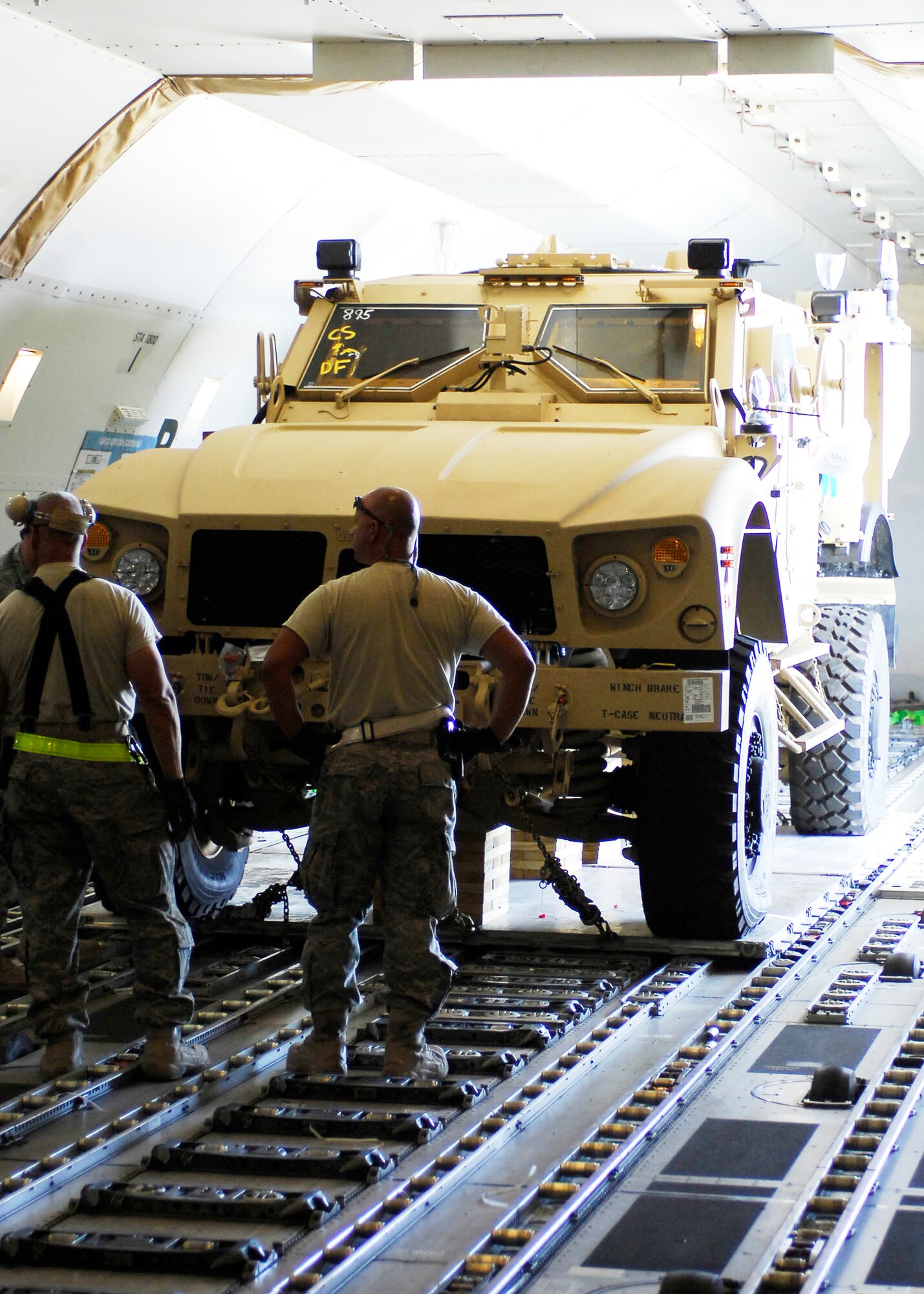 Airmen wait to unload a multipurpose all-terrain vehicle from a Boeing 747 Nov. 9, 2009, at Bagram Airfield, Afghanistan. The M-ATVs support mounted patrols, reconnaissance, security, convoy protection, communications, command and control, and combat service support. The M-ATV is designed to replace the up-armored Humvee in Afghanistan. The Airmen are assigned to the 455th Expeditionary Aerial Port Squadron. (U.S. Air Force photo/Senior Airman Felicia Juenke)