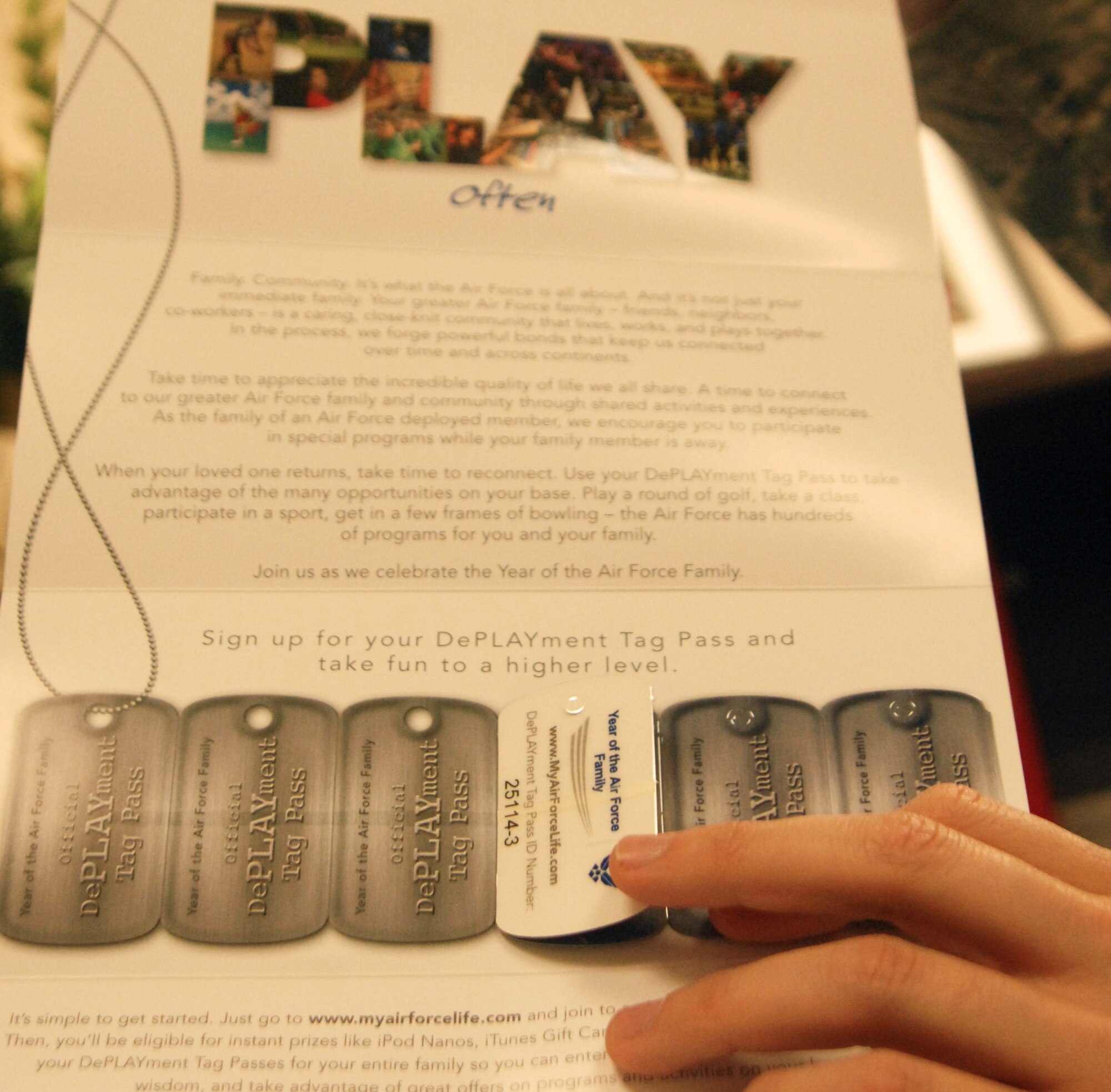Master Sgt. Brandon O’Neil, Readiness Noncommissioned Officer from Goodfellow AFB, Texas holds up a DePLAYment tags packet, Jan. 8.  The DePLAYment tags are offered to families of deployed members through July 31, 2010, as part of the Year of the Air Force Family and users can get discounted and even free family programs on base.  (U.S. Air Force photo/Robert D. Martinez)