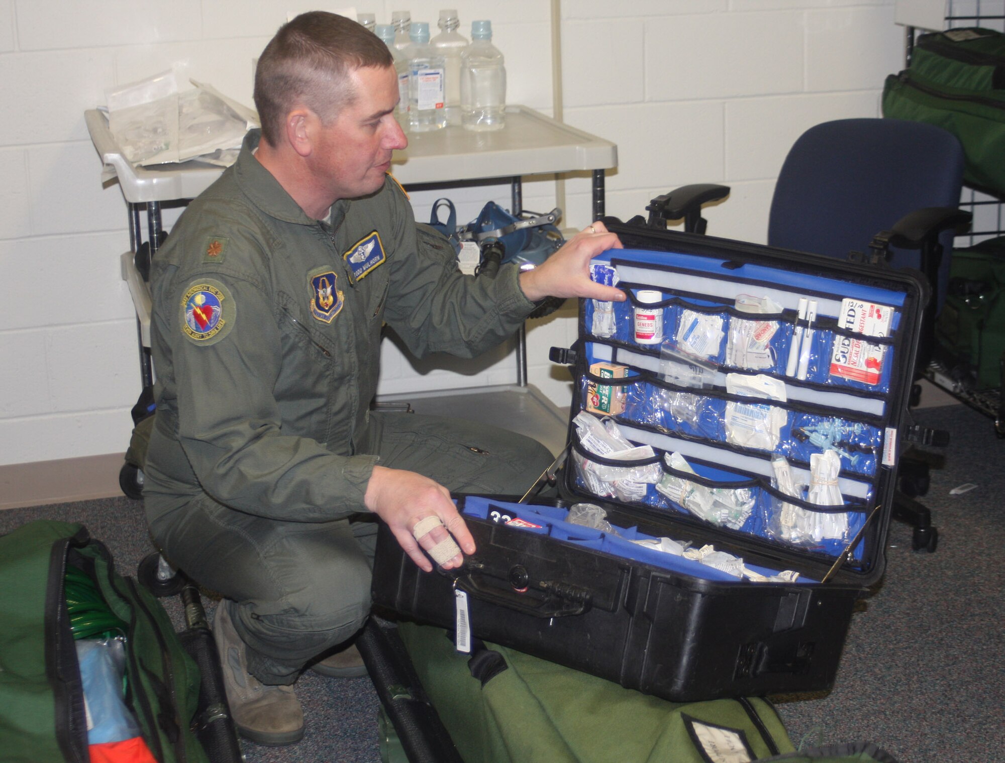 WRIGHT-PATTERSON AIR FORCE BASE, Ohio - Maj. Todd Mulhorn, 445th Aeromedical Evacuation Squadron operations officer, inventories a medical kit before a training flight.  AES members routinely inspect and inventory equipment used for training and real world missions. The reservists must "pre-flight" their medical equipment with operations and calibration checks. The inventory often includes everything from high-tech monitors, oxygen tanks and regulators to defibrillators. (U.S. Air Force photo/Stacy Vaughn)