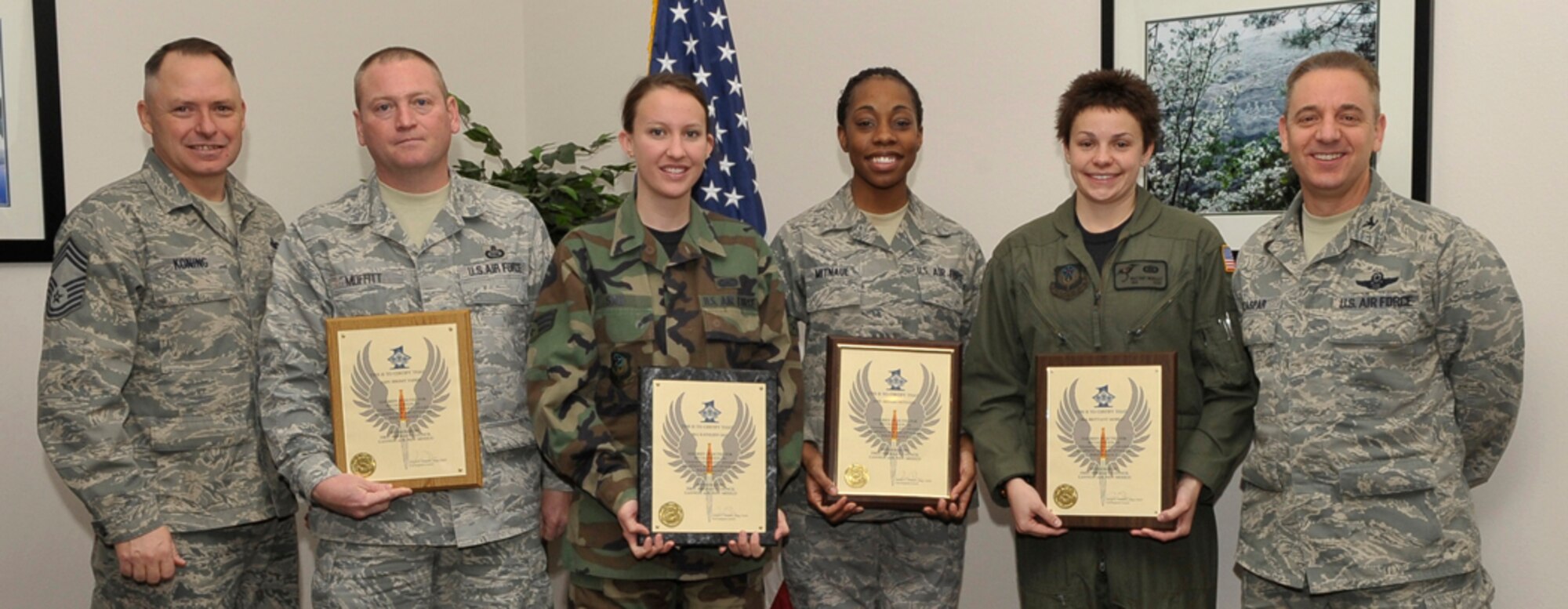 CANNON AIR FORCE BASE, N.M.-- (Left) Chief Master Sgt. Daniel Koning, 27th Special Operations Security Forces Squadron, and Colonel Ruedi Kaspar (right), 27th Special Operations Wing vice commander, stand with Diamond Sharp winners Jan. 8. Senior Master Sgt. James Moffitt (accepting the award for Airman Jeremy Farris), 27th Special Operations Support Squadron; Senior Airman A Kathleen Sao, 27th Special Operations Contracting Squadron; Airman Seenah Mitnaul, 27th Special Operations Medical Support Squadron; Senior Airman Brittany Mosely, 3rd Special Operations Squadron, were recognized for their superior job performance, leadership skills, as well as dress and appearance.  (U.S. Air Force photo by Staff Sgt. Heather R. Redman)