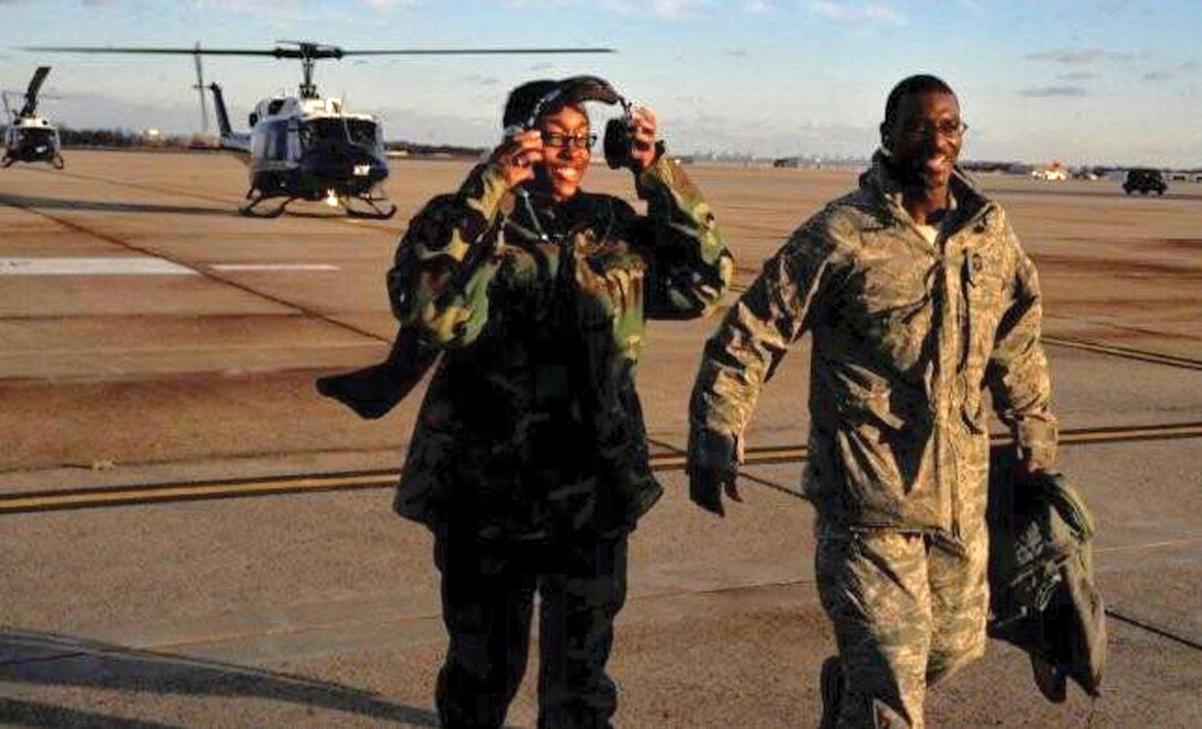 Airman 1st Class Charnique Jenkins, 316th Force Support Squadron force management representative, walks with Chief Master Sgt. James E. Davis, 316th Wing/Joint Base Andrews command chief, away from a 1st Helicopter Squadron UH-1 Huey helicopter after a flight around the National Capital Region Wednesday. Colonel Steven Shepro, 316 WG/Joint Base Andrews commander, and the chief invited the Airman on a flight as part of a new program; Shadow the Commander for a Day. Once a week the installation leadership invites an Airman to follow in their footsteps for a day and observe what goes into keeping the base running. The flight was part of the many activities Airman Jenkins joined Colonel Shepro for throughout her day with the commander. (U.S. Air Force photo/ Airman 1st Class Perry Aston)