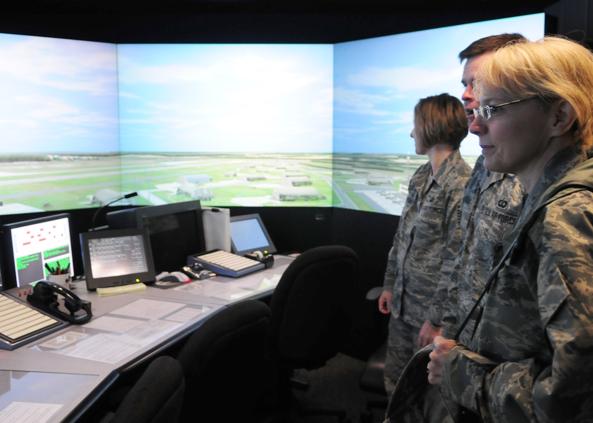 SPANGDAHLEM AIR BASE, Germany -- Chief Master Sgt. Pamela Derrow, U.S. Air Forces in Europe command chief, views an air traffic control training simulator with Tech. Sgt. Drew Spradley and Master Sgt. Tammy Kinder-Tims, both of the 52nd Operational Support Squadron, Jan. 8 at the air control tower.  The simulator provides a realistic training aid that keeps Airmen proficient in their skill set.  (U.S. Air Force photo/Staff Sgt. Heather M. Norris)   