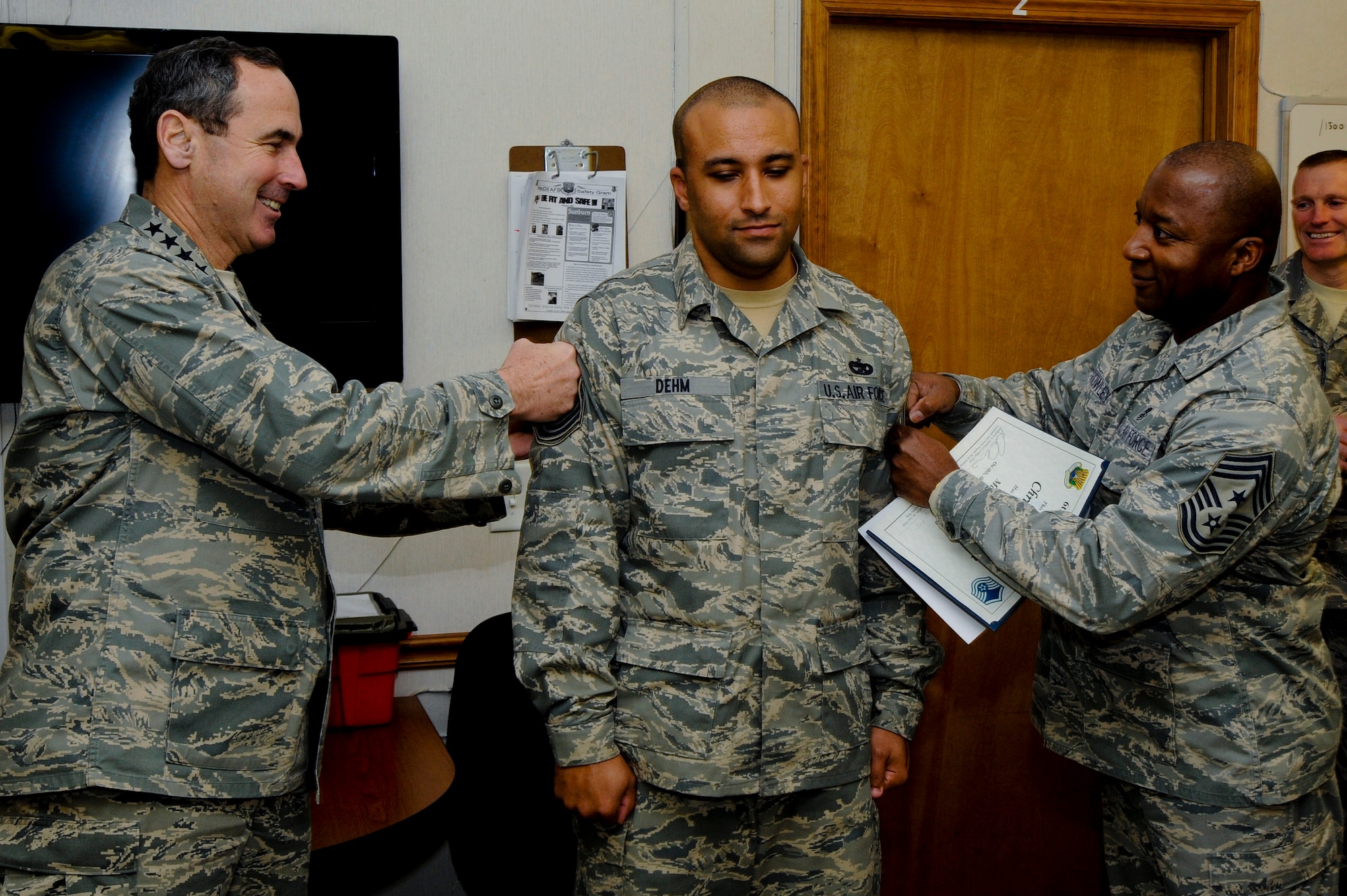 Tech. Sgt. Christopher Dehm, 6 Logistics Readiness Squadron, gets "tacked on" by Gen. Raymond E. Johns, Commander Air Mobility Command, and Chief Master Sgt. Derrick Crowley, 6 Air Mobility Wing Command Chief, here at MacDill Air Force Base Jan. 06, 2010. Sgt Dehm was selected for promotion to Master Sgt. under the Stripes for Exceptional Performers Program.
(U.S. Air Force photo by Staff Sgt. Joseph L. Swafford Jr./Released)
