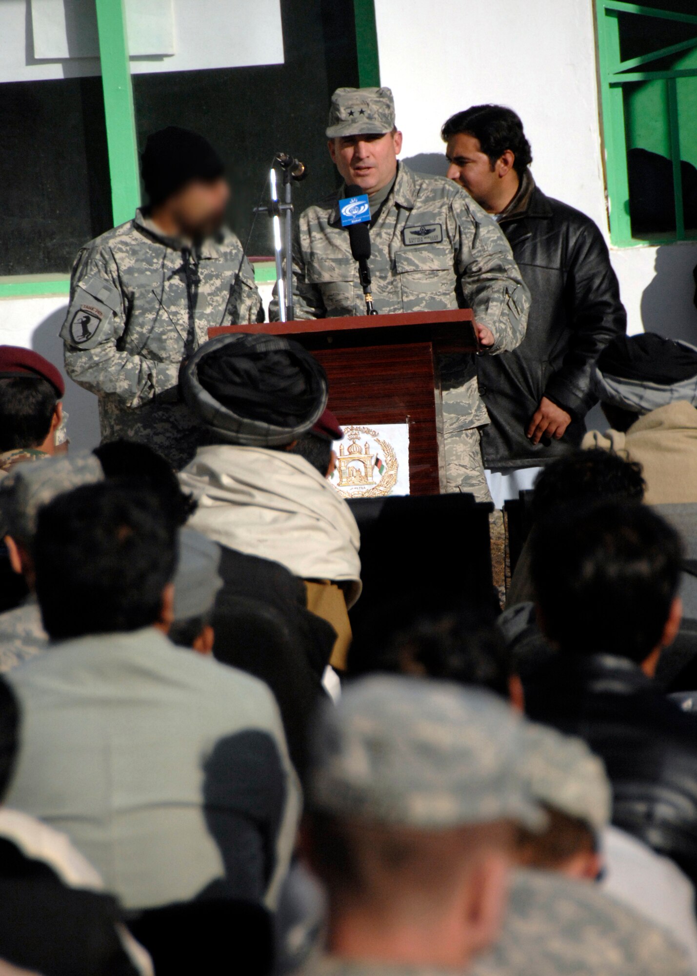 Maj. Gen. Stephen Mueller speaks to local Afghan community members during the cornerstone ceremony for a new, modern wing of the Zabul Provincial Hospital Dec. 26, 2009 in Qalat, Afghanistan. General Mueller is the U.S. Air Forces Central Air Component Coordination Element director.  (U.S. Air Force photo illustration/Senior Airman Timothy Taylor)