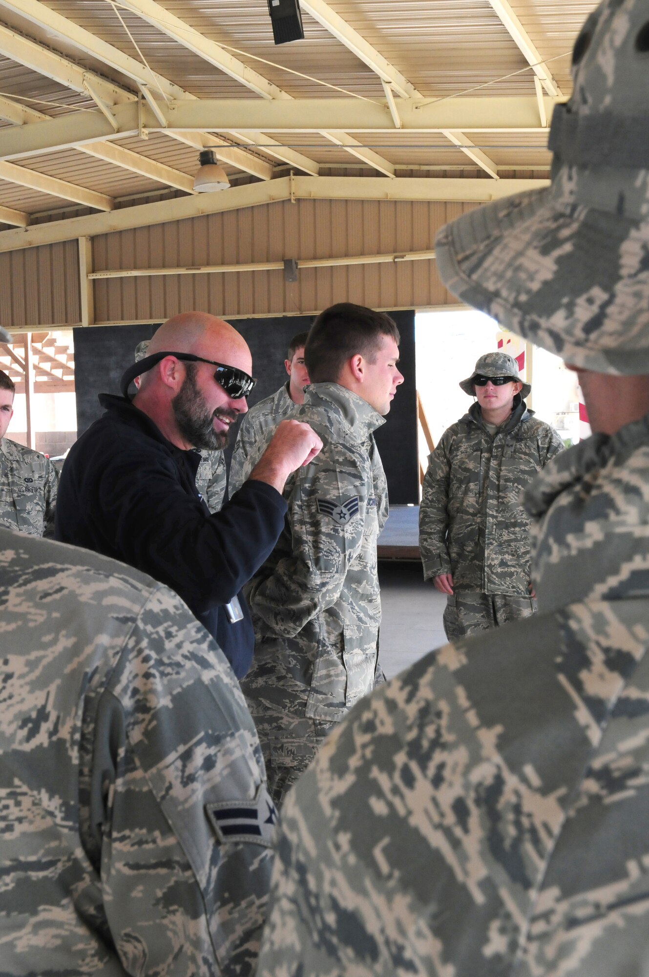 SOUTHWEST ASIA  -- Jeff Jones, 386th Expeditionary Security Forces Squadron trainer, instructs force protection Airmen on how to restrain and search individuals Jan. 8, 2010 at an air base in Southwest Asia. The training is conducted on a quarterly basis to give incoming personnel the basics of force protection techniques. (U.S. Air Force photo by Staff Sgt. Lakisha A. Croley/Released)
