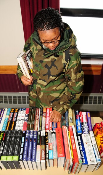 NIAGARA FALLS AIR RESERVE STATION, NY--Technical Sgt Regina Tell, 914th Airlift Wing, browses the book selection at the Airman and Family Readiness Center, January 5. Books are donated by various sources in the local community in support of deploying troops. (U.S. Air Force photo by Staff Sgt Stephanie Clark) (Released)   