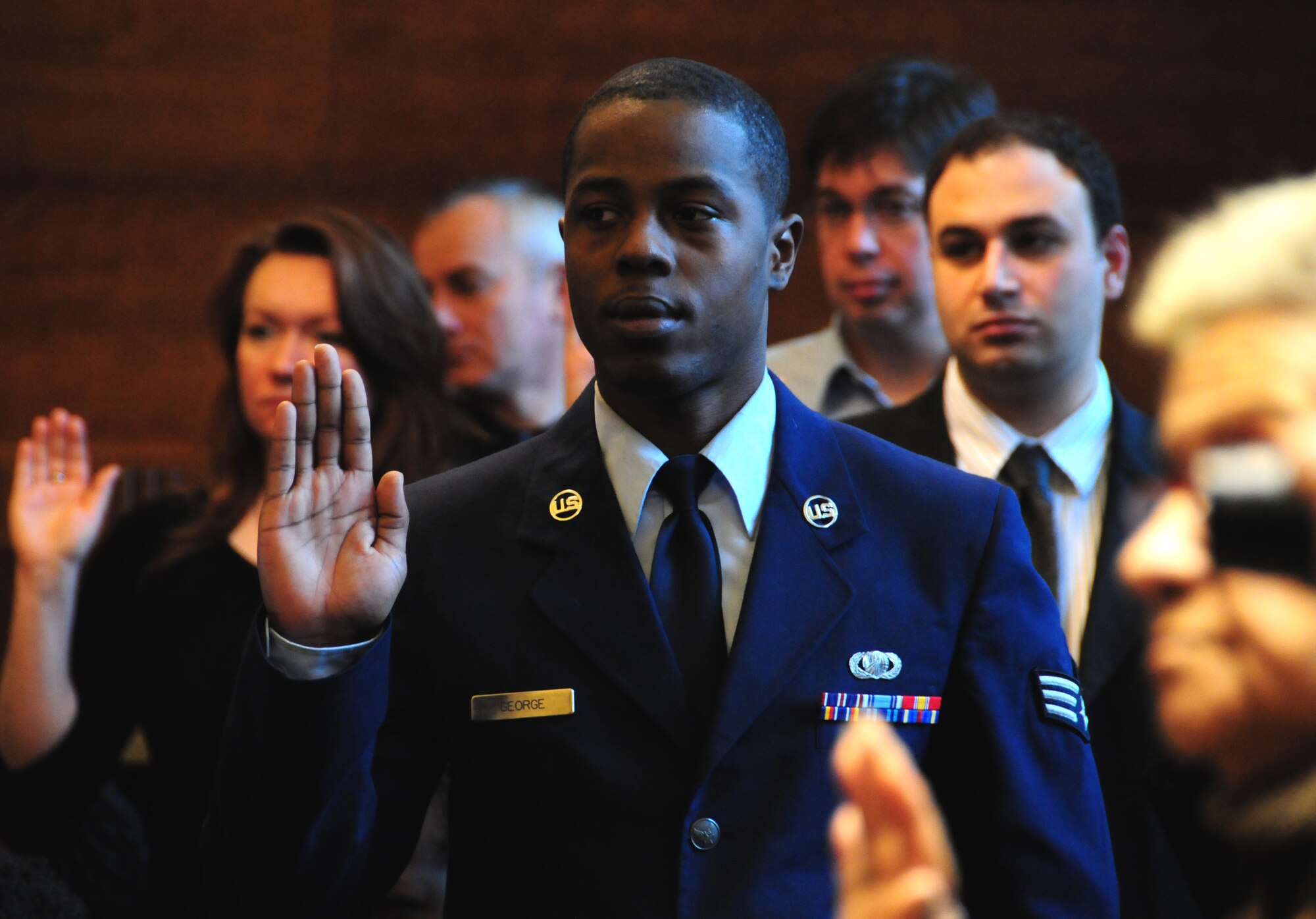 NIAGARA FALLS AIR RESERVE STATION, NY--Senior Airman Christopher George, 914 Airlift Wing, takes an oath of allegiance as part of a naturalization ceremony to signify United States citizenship. SrA George is originally from Guyana, South America.  (U.S. Air Force photo by Staff Sgt Stephanie Clark) (Released)