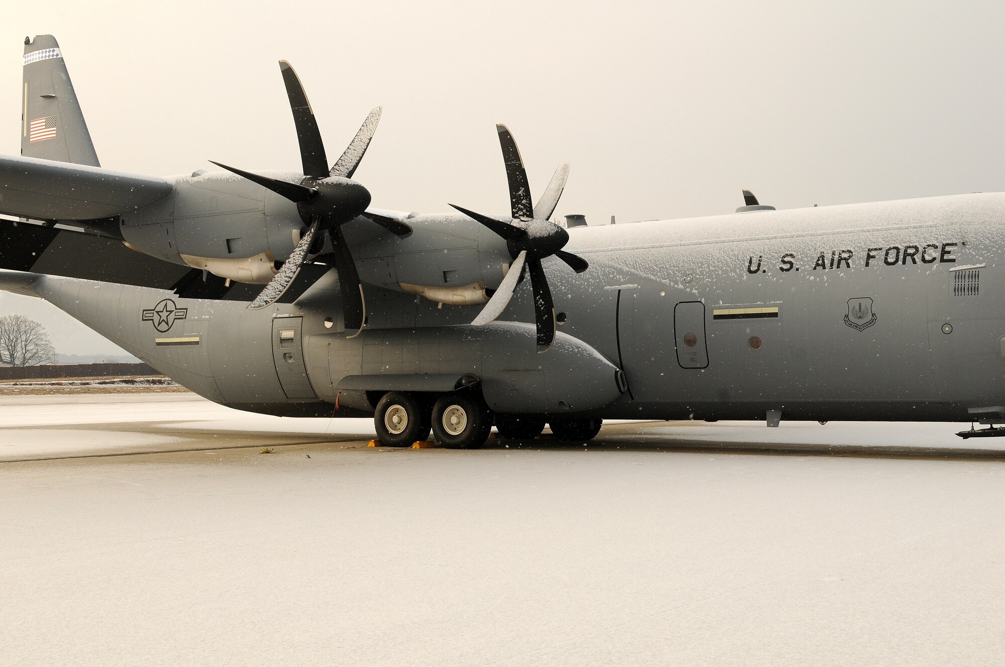 Snow clings to a C-130J as inclement weather descends on Ramstein Air Base, Germany, January 7, 2010. (U.S. Air Force photo by Airman 1st Class Brea Miller)