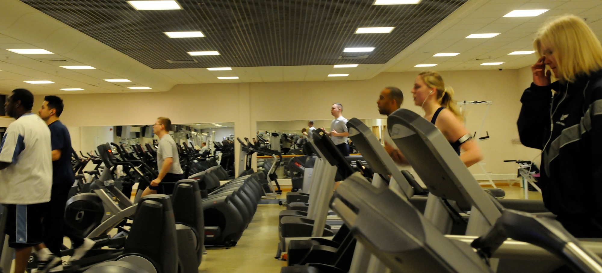 RAF MILDENHALL, England -- Base community members work out on tread mills, stationary bikes and elliptical machines during the cold and snowy winter months Jan. 8th.  Winter can be a time of year when staying indoors and eating a lot can put fitness on the sidelines.  (U.S. Air Force photo/staff Sgt. Christopher L. Ingersoll)