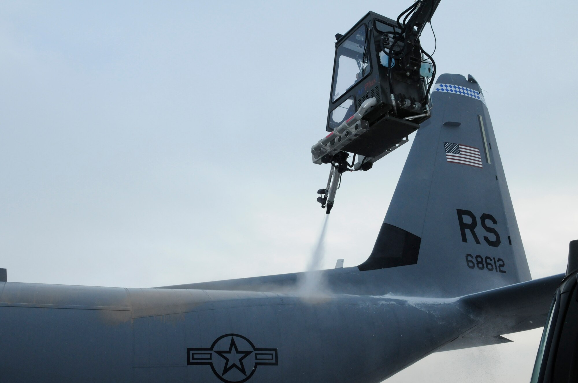 U. S. Air Force Senior Airman Brian Noonkester, crane operator, 86th Aircraft Maintenance Squadron, sprays a C130J with deicing solution at Ramstein Air Base, Germany, Jan. 07, 2010. Deicing planes on the flight line is paramount for the safety of the pilots, passengers, and equipment in the winter weather season. (U.S. Air Force photo by Airman Desiree Esposito)