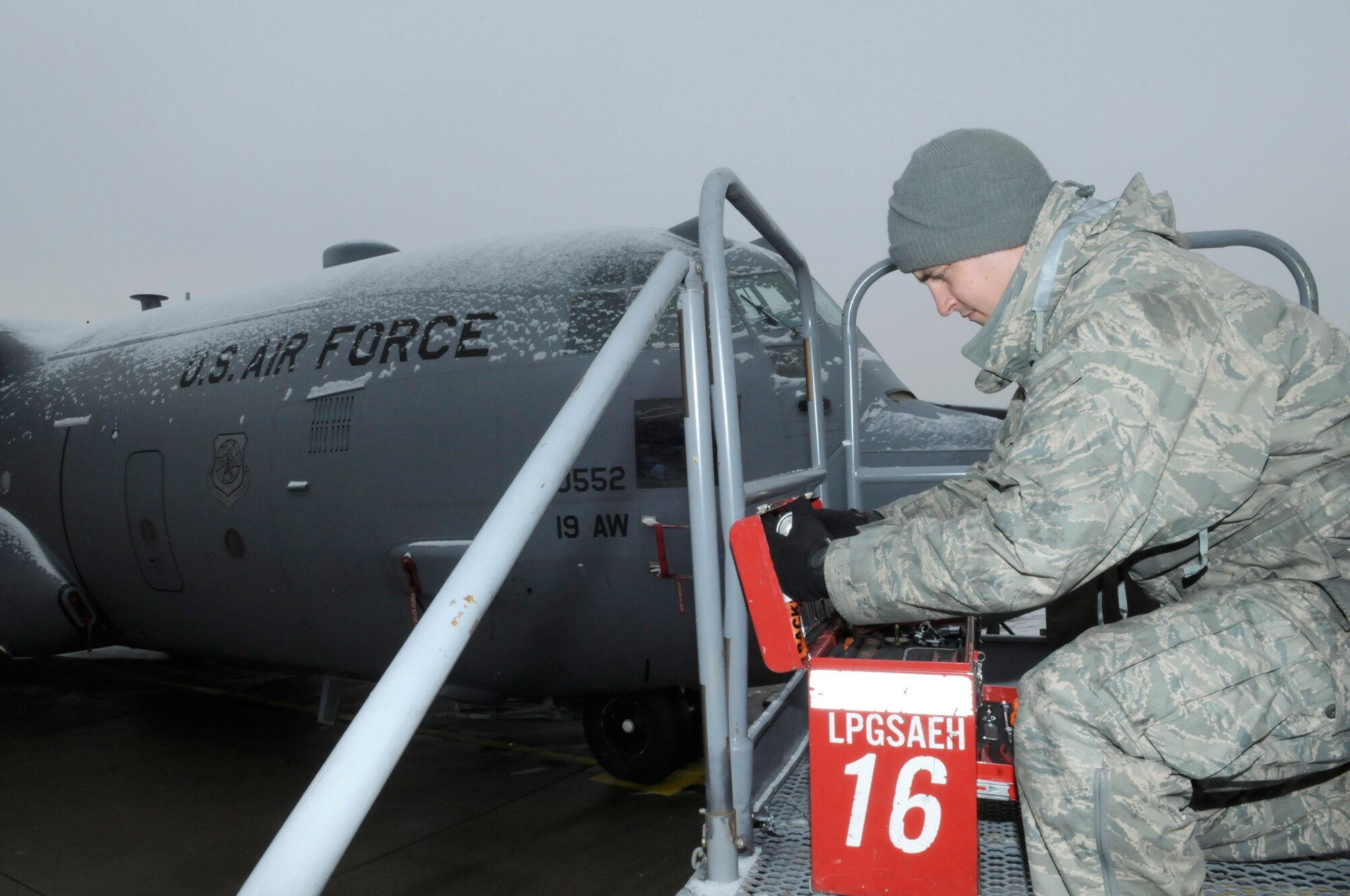 U.S. Air Force Staff Sgt. Phillip Crandall, aircraft maintainer, 38th Expeditionary Airlift Squadron  gathers equipment in preparation for a C-130J Hercules nose cone removal on Ramstein Air Base, Germany Jan. 07, 2010. SSgt Crandall is currently on temporary duty at Ramstein Air Base from the 19th Aircraft Maintenance Squadron, Little Rock Air Force Base, Ark. (U.S. Air Force photo by Airman Desiree Esposito)