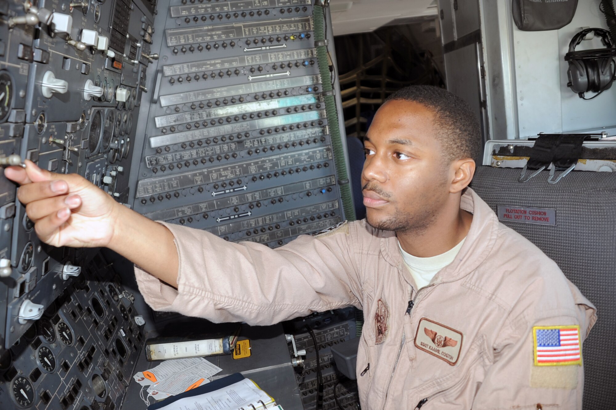 Staff Sgt. Kaamil Coston, KC-10 Extender flight engineer with the 908th Expeditionary Air Refueling Squadron at a non-disclosed base in Southwest Asia, works at his station in a KC-10 Jan. 8, 2009.  Sergeant Coston, deployed from the 2nd Air Refueling Squadron at McGuire Air Force Base, N.J., ensures the KC-10 is ready to fly when a mission is prepared -- essentially the "systems expert" for the airframe.  The KC-10 is an Air Mobility Command advanced tanker and cargo aircraft designed to provide increased global mobility for U.S. armed forces. Although the KC-l0's primary mission is aerial refueling, it can combine the tasks of a tanker and cargo aircraft by refueling fighters and simultaneously carry the fighter support personnel and equipment on overseas deployments. Sergeant Coston's hometown is Staten Island, N.Y.  (U.S. Air Force Photo/Tech. Sgt. Scott T. Sturkol/Released) 