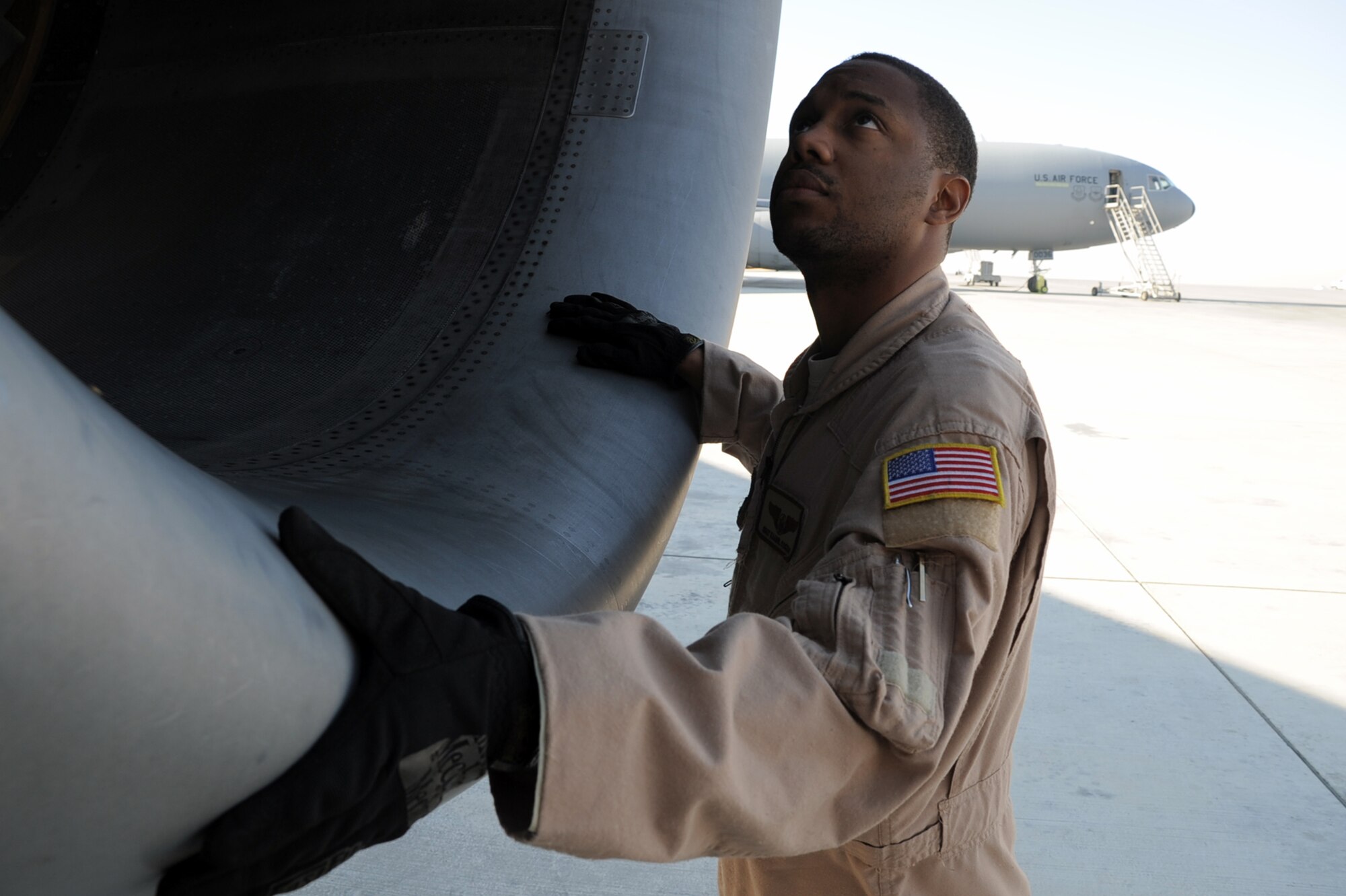Staff Sgt. Kaamil Coston, KC-10 Extender flight engineer with the 908th Expeditionary Air Refueling Squadron at a non-disclosed base in Southwest Asia, checks an engine of a KC-10 Jan. 8, 2009.  Sergeant Coston, deployed from the 2nd Air Refueling Squadron at McGuire Air Force Base, N.J., ensures the KC-10 is ready to fly when a mission is prepared -- essentially the "systems expert" for the airframe.  The KC-10 is an Air Mobility Command advanced tanker and cargo aircraft designed to provide increased global mobility for U.S. armed forces. Although the KC-l0's primary mission is aerial refueling, it can combine the tasks of a tanker and cargo aircraft by refueling fighters and simultaneously carry the fighter support personnel and equipment on overseas deployments. Sergeant Coston's hometown is Staten Island, N.Y.  (U.S. Air Force Photo/Tech. Sgt. Scott T. Sturkol/Released) 
