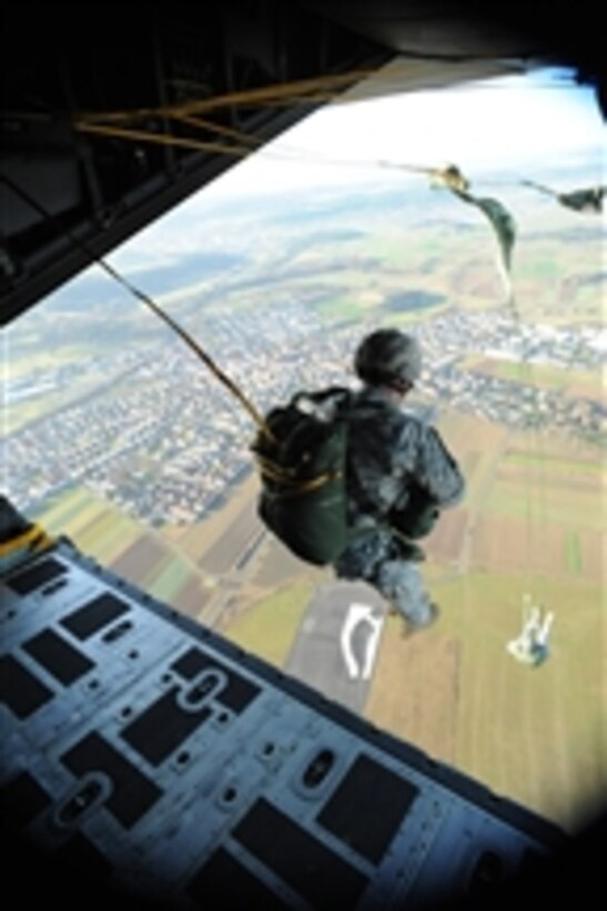 Members of Special Operations Command Europe jump from the ramp of an MC-130 Combat Talon aircraft over Malmshein Drop Zone in Stuttgart, Germany, on Dec. 9, 2009.  