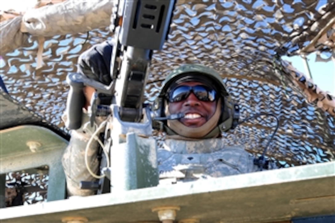 U.S. Army Spc. Kelly James, with 8th Squadron, 1st Cavalry Regiment, smiles from the air guard position of a Stryker armored vehicle in Taktehpol, Afghanistan, on Jan. 4, 2010.  