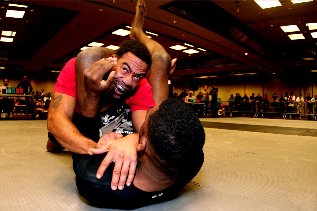 Dominic Waters (in red), a 165-pound fighter with the Combat Center’s Fight Club 29, works his way out of his opponent's legs during the Grappling Experience Tournament in Las Vegas Jan. 9. Waters won the match and earned a silver medal in the tournament.