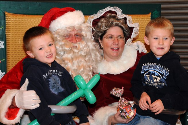 The Utah Air National Guard held its annual Children's Christmas Party December 12 at the Utah ANG Base.  Garrett and Caden Baker, sons of Master Sgt. Burke Baker of the 151st Air Refueling Wing, tell Santa and Mrs. Claus what they want for Christmas.  The party included a variety of children?s activities, including face painting, crafts and performing clowns. U.S. Air Force Photo by: Staff Sgt. Emily Monson (RELEASED)