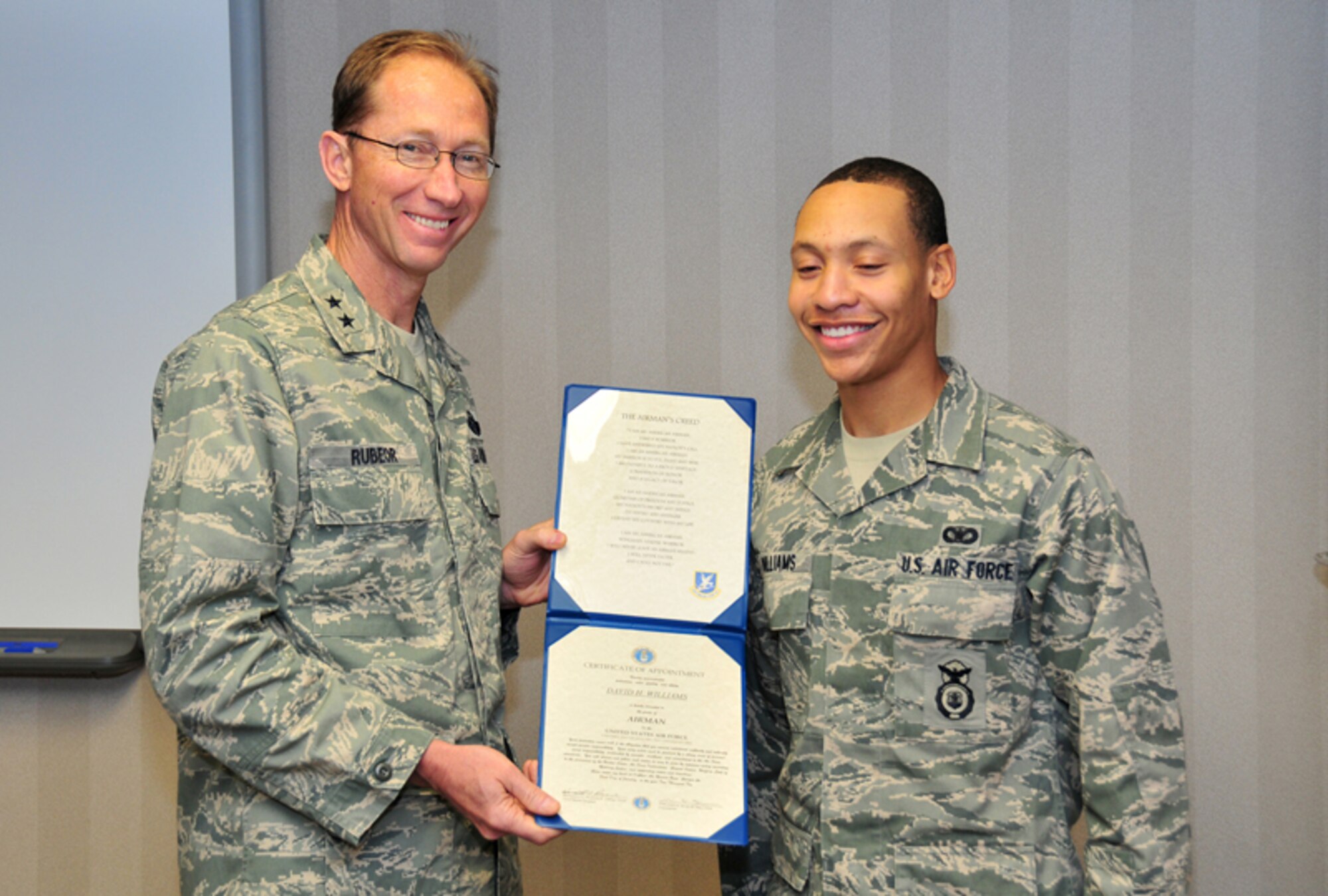 Maj. Gen. James T. Rubeor, commander, 22nd Air Force presents a Certificate of Appointment to Airman David H. Williams, security forces apprentice, 94th Security Forces Squadron, during his promotion ceremony Jan. 9. General Rubeor visited the Airmen of the 94th Airlift Wing during the Unit Training Assembly as part of his commitment to visit every unit in the 22nd Air Force and ensure everyone has the necessary facilities and training they need to complete their mission. (U.S. Air Force photo: Tech. Sgt. Nicholas Ontiveros)