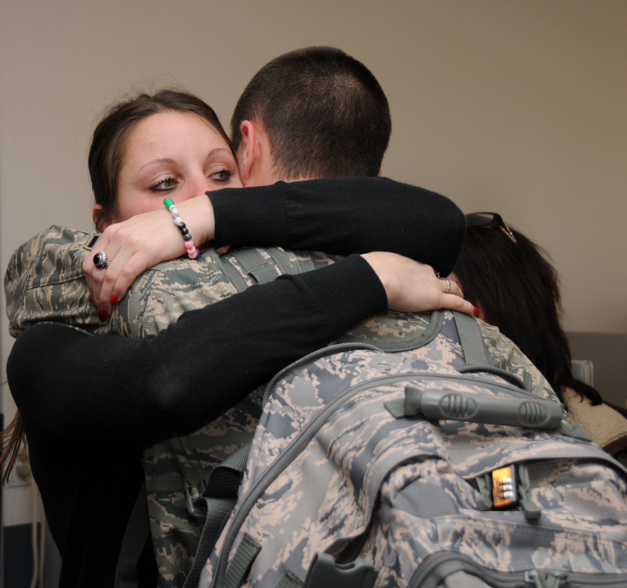 A member of the 188th Fighter Wing hugs a family member prior to departing for Afghanistan Jan. 4, 2010. The 188th deployed approximately 50 Airmen to Afghanistan for a four-month Aerospace Expeditionary Force (AEF) rotation. The remainder of the 188th personnel, approximately 250, will begin its portion of the rotation in March 2010, when the 188th's official rotation begins. (U.S. Air Force photo by Tech. Sgt. Stephen Hornsey)