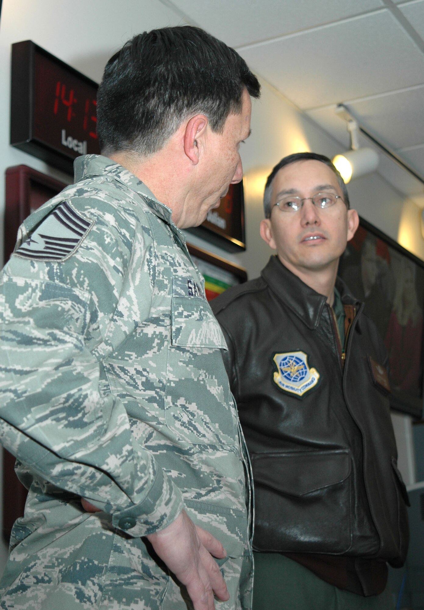 Chief Master Sgt. Mike Sanchez, 302nd Maintenance Group production superintendent, discusses maintenance challenges with Lt. Col. Chris Cantu Jan. 8 at Peterson Air Force Base, Colo. Colonel Cantu, acting commander for the 19th Operations Group based at Little Rock AFB, Ark., visited the Air Force Reserve's 302nd Airlift Wing at Peterson to get a better look at operations and maintenance personnel and the challenges they face as they continue to integrate with Active Duty Airmen of the 52nd Airlift Squadron. Both the squadron and the 302nd AW have combined under Total Force Integration to make effective use of C-130 Hercules aircraft in support of Air Force objectives. (U.S. Air Force photo/Staff Sgt. Stephen J. Collier)