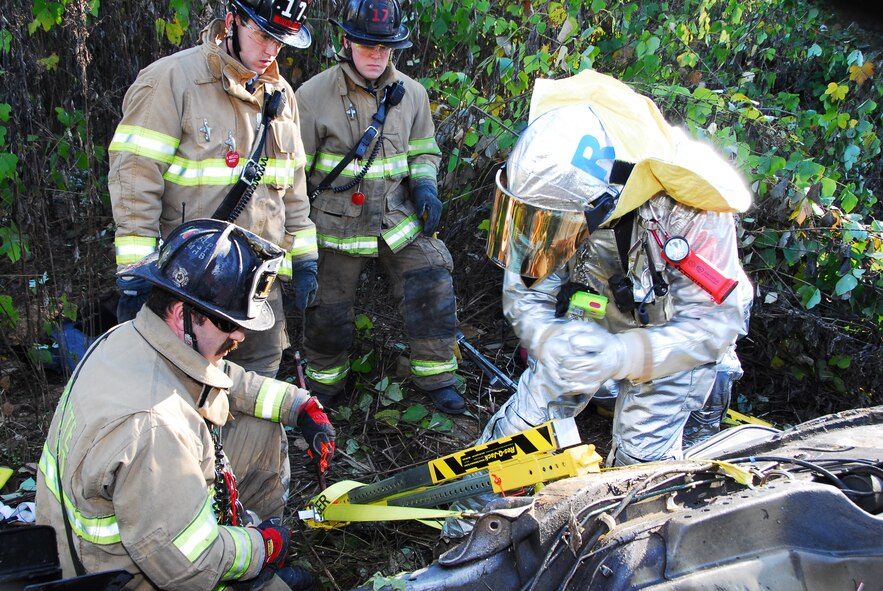 Charlotte Air National Guard Base, NC – Using hydraulic-powered tools, emergency responders from North Carolina Air National Guard’s 145th Civil Engineering Squadron work with contemporaries from the Charlotte Fire Department to extricate passengers of a car during a simulation exercise conducted here recently. The exercise replicated an event encountered while the unit was deployed in Iraq, in which a vehicle was discovered upside-down at the bottom of a ravine. The North Carolina Air National Guard responds to in-state emergencies, EMAC designated contingencies and federal instances of homeland defense. The unit currently has members deployed I support of Operations Enduring Freedom and Iraqi Freedom and continues to support the War on Terror. Photo by Staff Sgt. Richard Kerner, 145th AW Public Affairs
