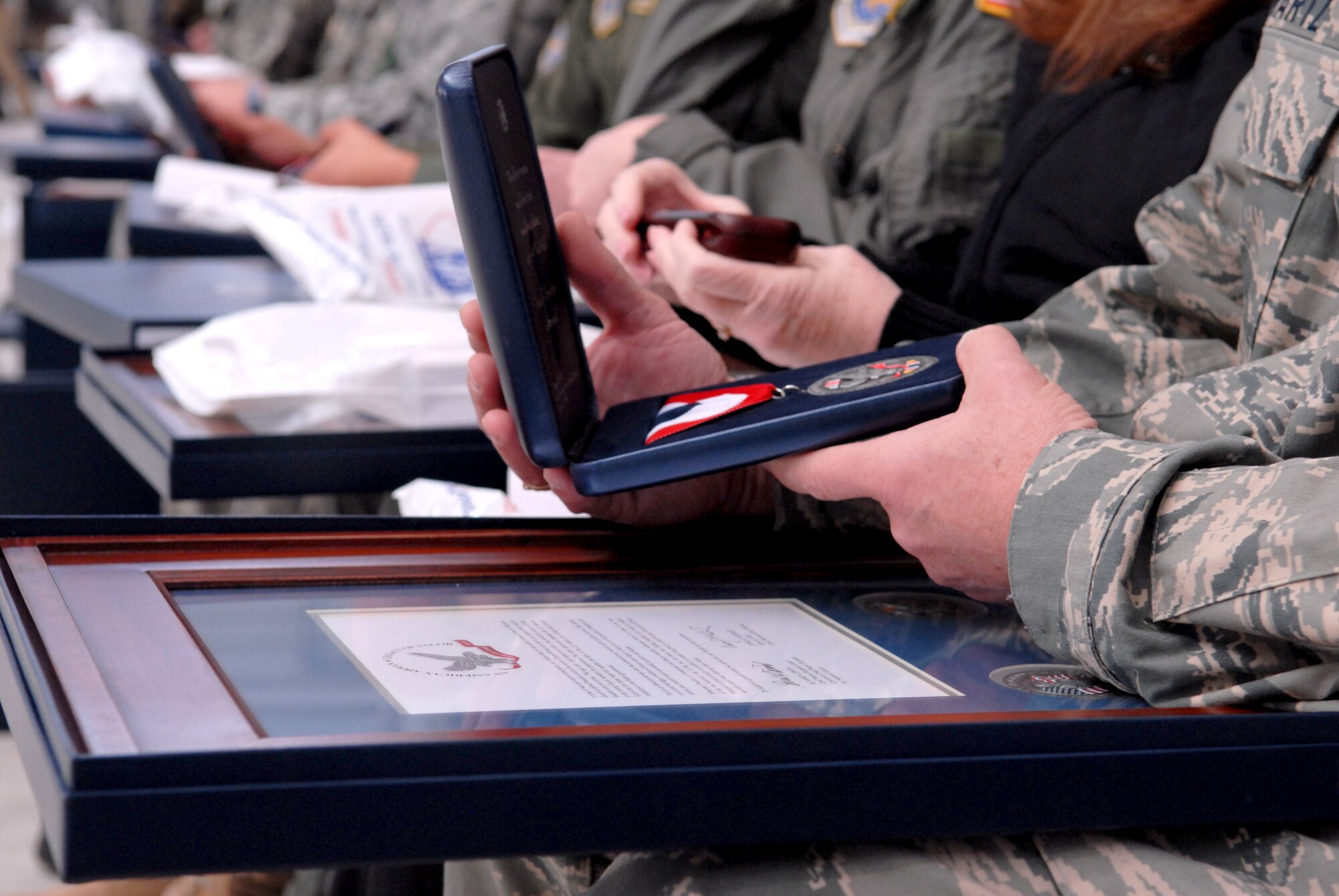 Airmen from the 167th Airlift Wing look at the various items they were presented during the units first Hometown Heroes Salute recognition program on Sunday December 6, 2009. In August 2008, Gen. Craig R. McKinley, chief of the National Guard Bureau, sanctioned the ANG Hometown Heroes Salute recognition program. The purpose of this program is to celebrate and honor Airmen, families, communities and those special supporters who have significantly contributed to supporting our Airmen and ANG?s mission. (U.S. Air Force photo by SSgt Julie Lozinski)