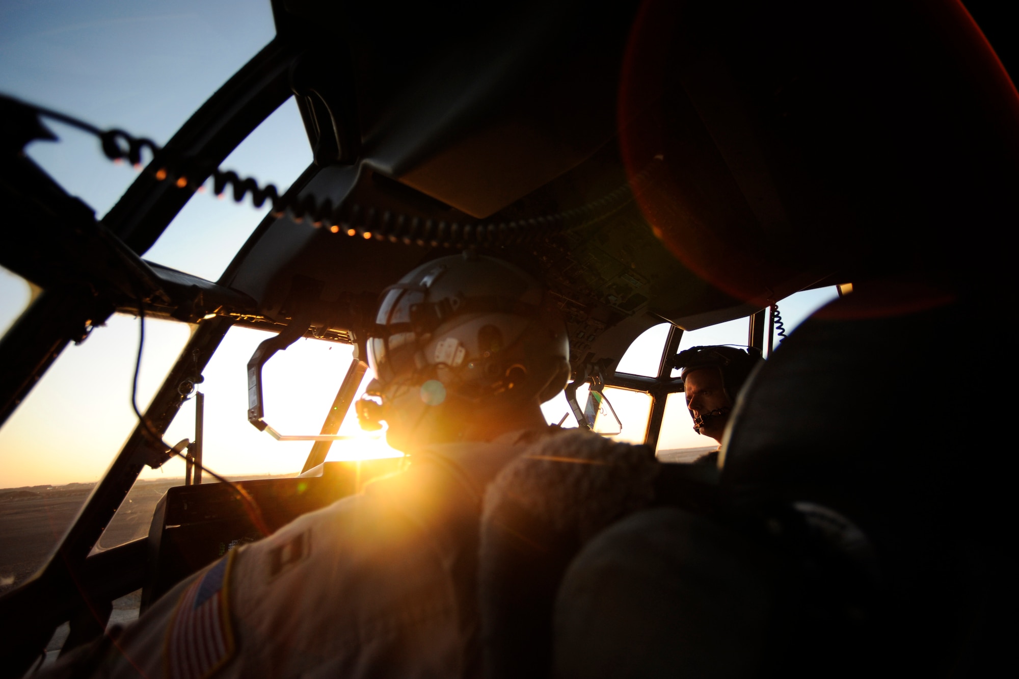 Capt. Dave Paland, (left) and Canadian Air Force Capt. Ryan Peters, both 772nd Expeditonary Airlift Squadron C-130J pilots, wait to take-off during a routine channel mission, Jan. 7. at Camp Bastion, Afghanistan. Capt. Paland is deployed from Little Rock Air Force Base, Ark,. A routine channel mission is a twelve-hour shift to deliver passengers and cargo to various locations throughout Afghanistan. (U.S. Air Force/Staff Sgt. Manuel J. Martinez)