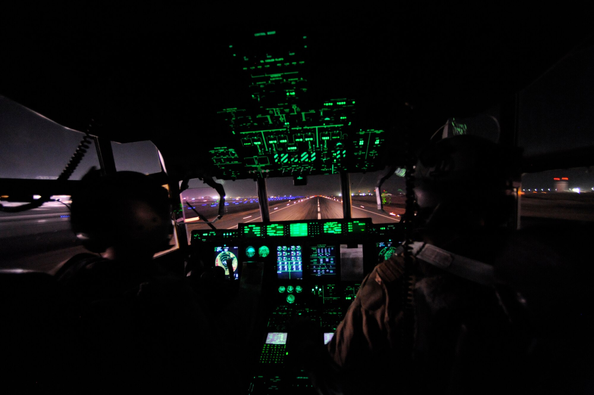 Capt. Dave Paland, (left) and Canadian Capt. Ryan Peters, both 772nd Expeditonary Airlift Squadron C-130J pilots,  land their C-130J Super Hercules aircraft to drop off cargo and passengers during a routine channel mission, Jan. 6, at Bagram Air Base,  Afghanistan. The routine channel consisted of a twelve-hour shift with almost five hours of flight time, six takeoffs and six landing to deliver passengers and cargo to various locations throughout Afghanistan.  (U.S. Air Force/Staff Sgt. Manuel J. Martinez)