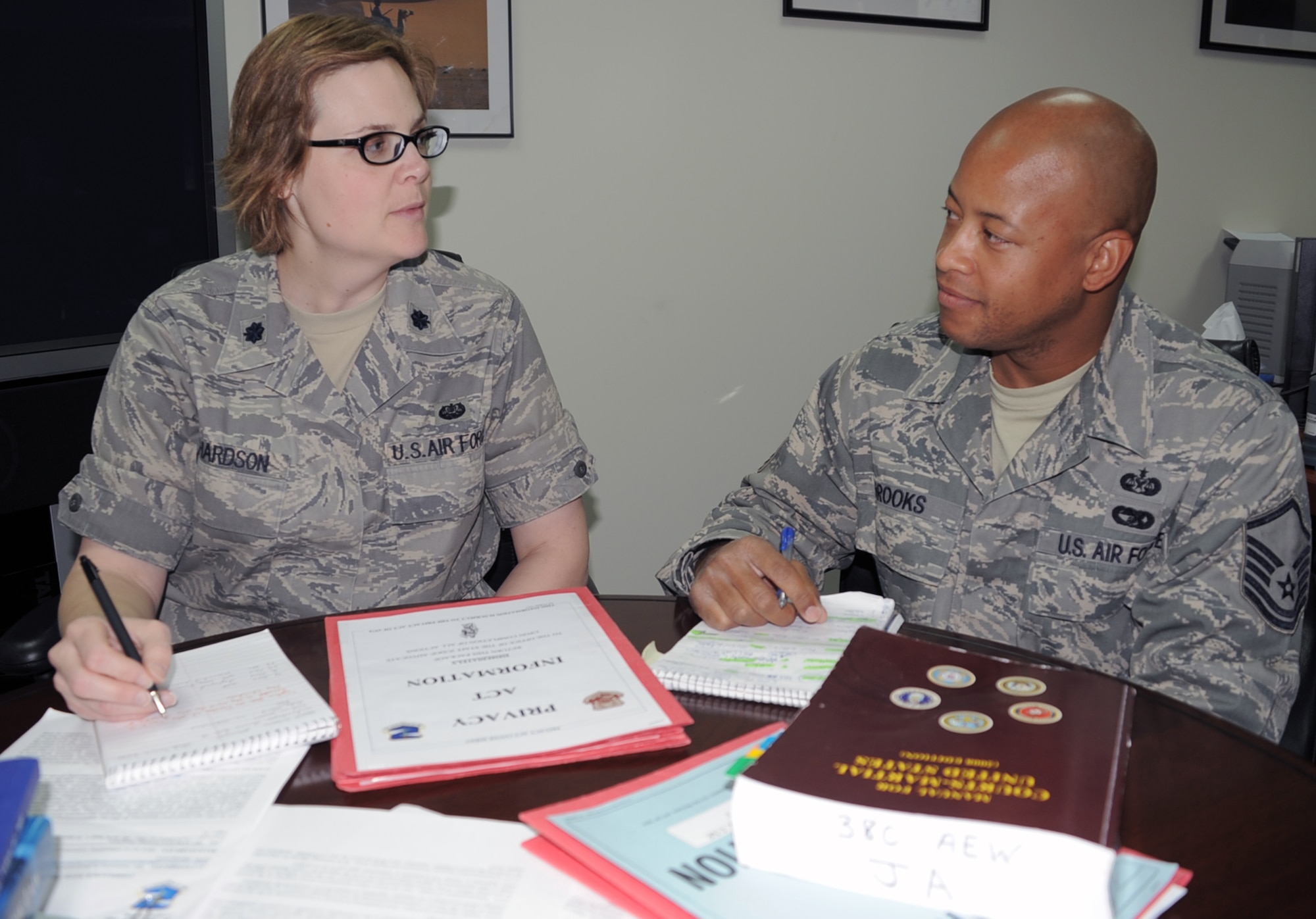 Lt. Col. Natalie D. Richardson, staff judge advocate for the 380th Air Expeditionary Wing and Master Sgt. Shawn Brooks, legal office superintendent, hold a planning session in their office at a non-disclosed base in Southwest Asia. Among the many things a deployed legal office staff completes, they include preparing and notarizing powers of attorney, advising clients on personal civil legal matters, advising units about fiscal law and ethics issues, advising investigating officers about giving rights advisements, and advising commanders about action under the Uniform Code of Military Justice.  Colonel Richardson is deployed from Wright-Patterson Air Force Base, Ohio, and her hometown is Orange County, Calif.  Sergeant Brooks is deployed from Air Education and Training Command Headquarters at Randolph AFB, Texas, and his hometown is Brooklyn, N.Y. (U.S. Air Force Photo/Tech. Sgt. Scott T. Sturkol)