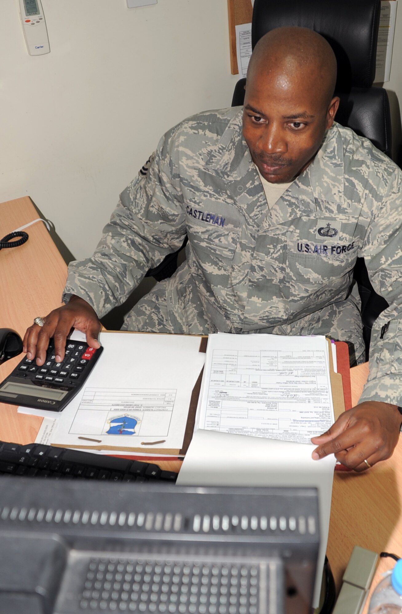 Tech. Sgt. Craig Castleman, a contracting craftsman with the 380th Expeditionary Contracting Squadron at a non-disclosed base in Southwest Asia, works on a contract in his office at his deployed location Jan. 8, 2009. Sergeant Castleman, deployed from the 43rd Contracting Squadron at Pope Air Force Base, N.C., is the 380th ECONS contingency contracting flight chief.  His hometown is Shelbyville, Tenn. (U.S. Air Force Photo/Tech. Sgt. Scott T. Sturkol/Released)
