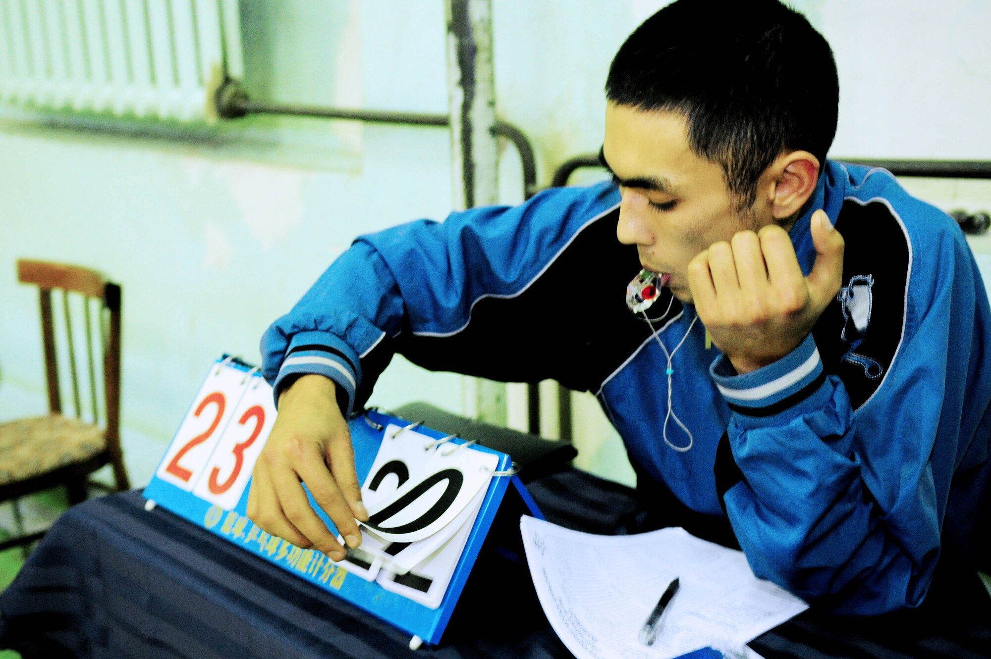 BISHKEK, Kyrgyzstan - The Kyrgyz scorekeeper from the Academy of Physical Culture and Sports counts a point for the Transit Center at Manas' volleyball team here Jan. 8. The Kyrgyz team is comprised of full-time athletes, while TC team is primarily made up military servicemembers. (U.S. Air Force photo by Senior Airman Nichelle Anderson)