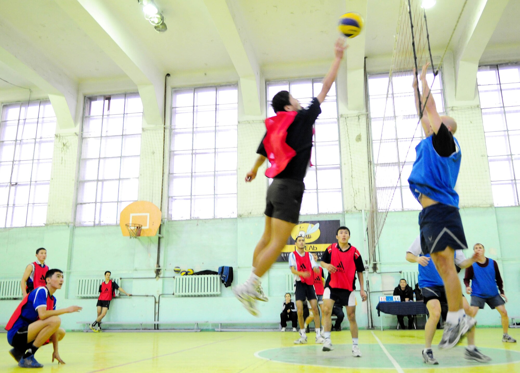 BISHKEK, Kyrgyzstan - An athlete from the Academy of Physical Culture and Sports attempt to dink the volleyball over the Transit Center at Manas team's defense here Jan. 8. The Kyrgyz team is comprised of full-time athletes, while the TC team is primarily made up of military servicemembers. In spite of the American's loss, the friendly relationship established during the match helped build a strong community bond. (U.S. Air Force photo by Senior Airman Nichelle Anderson)