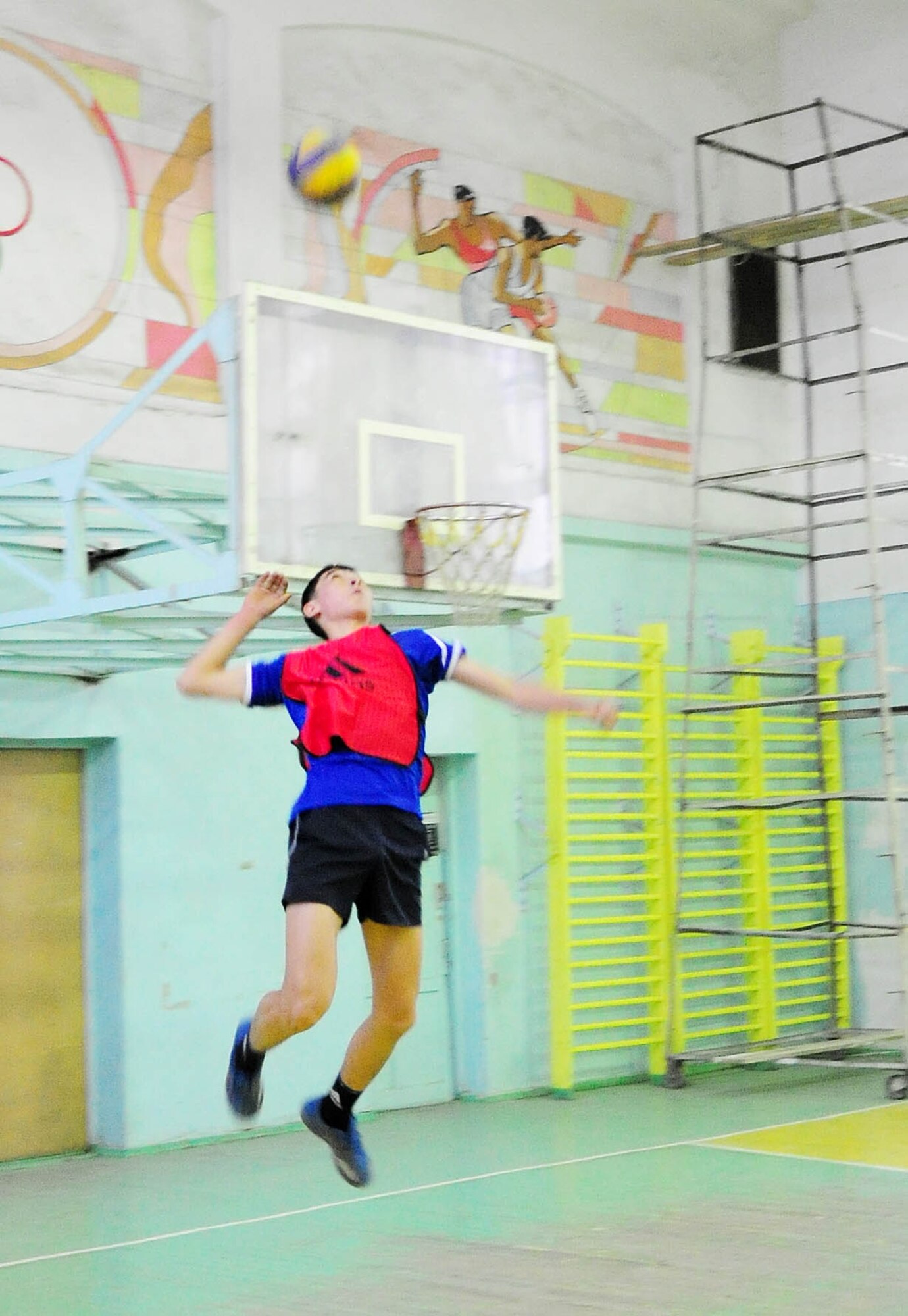 BISHKEK, Kyrgyzstan - An athlete from the Academy of Physical Culture and Sports goes up for a jump serve during a friendly volleyball match against the Transit Center at Manas team here Jan. 8. The Kyrgyz team is comprised of full-time athletes, while the TC team is primarily made up of military servicemembers. (U.S. Air Force photo by Senior Airman Nichelle Anderson)