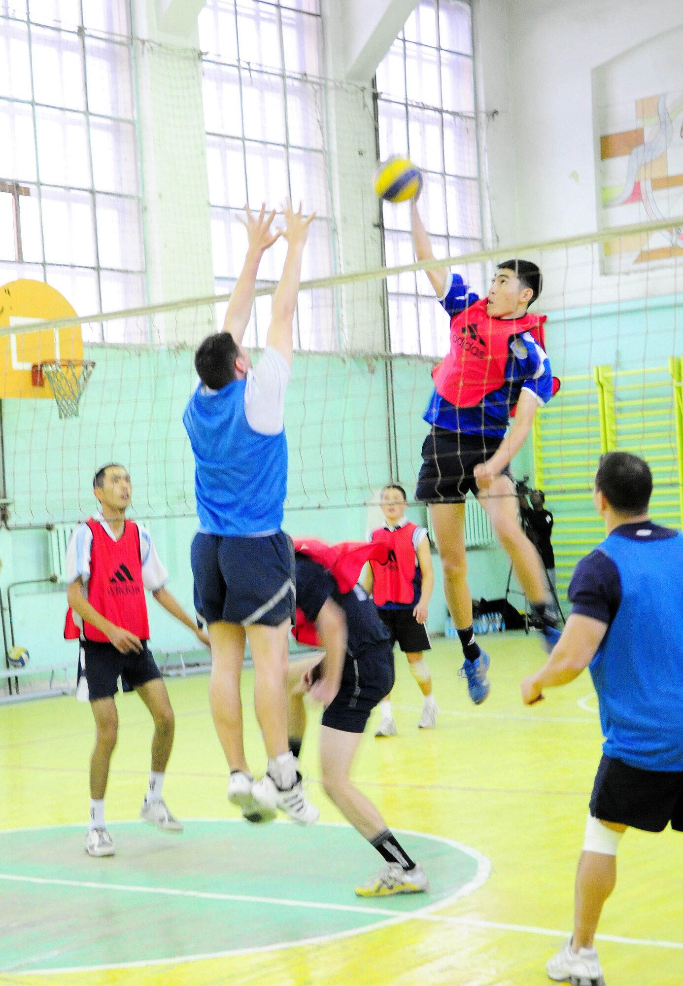 BISHKEK, Kyrgyzstan - An athlete from the Academy of Physical Culture and Sports spikes the volleyball against the Transit Center at Manas team here Jan. 8. The Kyrgyz team is comprised of full-time athletes, while the TC team is primarily made up of military servicemembers. In spite of the Airmen?s loss, the friendly conduct between the two teams was evident throughout the event. (U.S. Air Force photo by Senior Airman Nichelle Anderson)