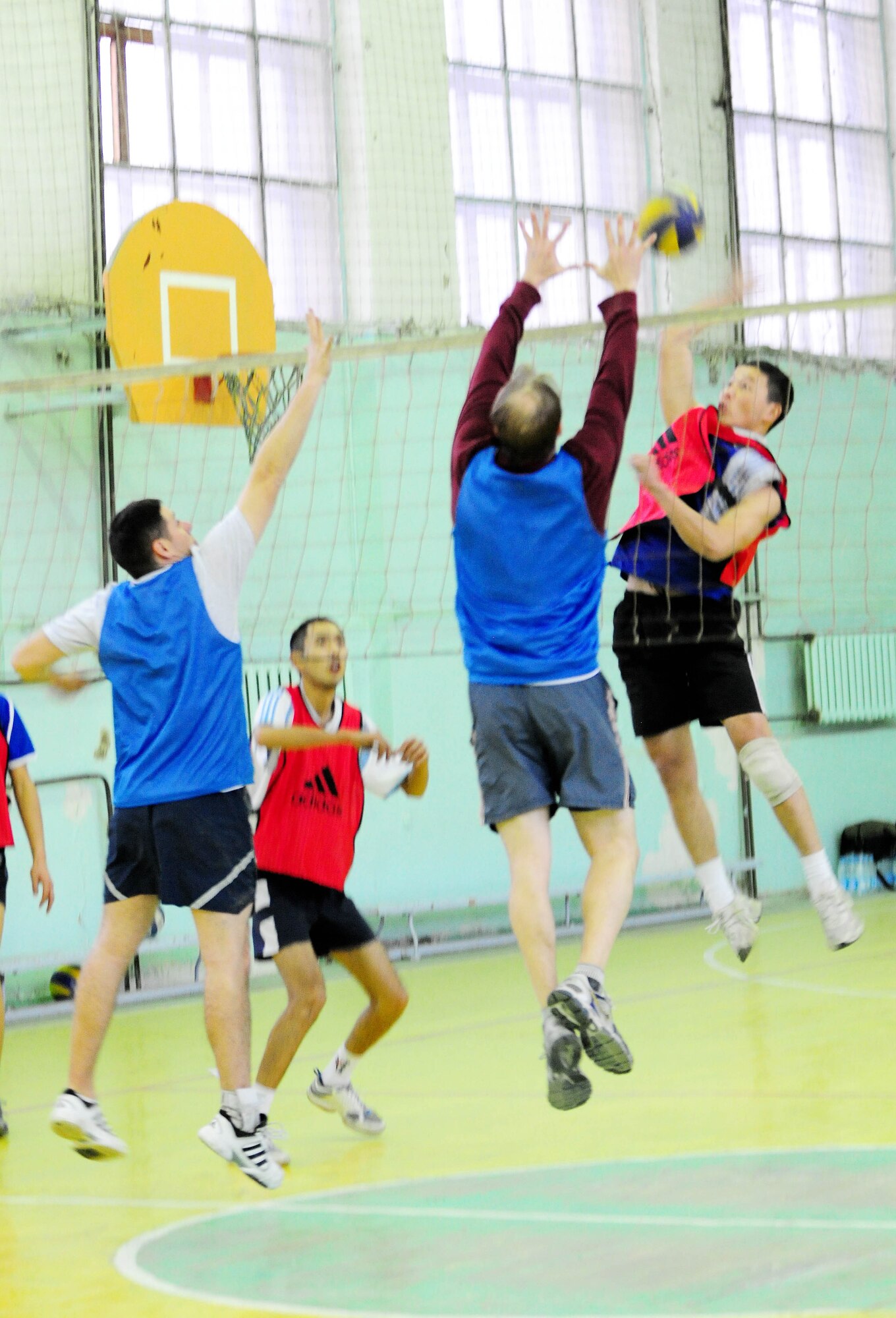 BISHKEK, Kyrgyzstan - An athlete from the Academy of Physical Culture and Sports goes up for a spike during a friendly volleyball match against the Transit Center at Manas team Jan. 8. The Kyrgyz team is comprised of full-time athletes, while the TC team is primarily made up of military servicemembers. In spite of the American?s loss, the friendly relationship established between the two teams helped build a strong community bond. (U.S. Air Force photo by Senior Airman Nichelle Anderson)