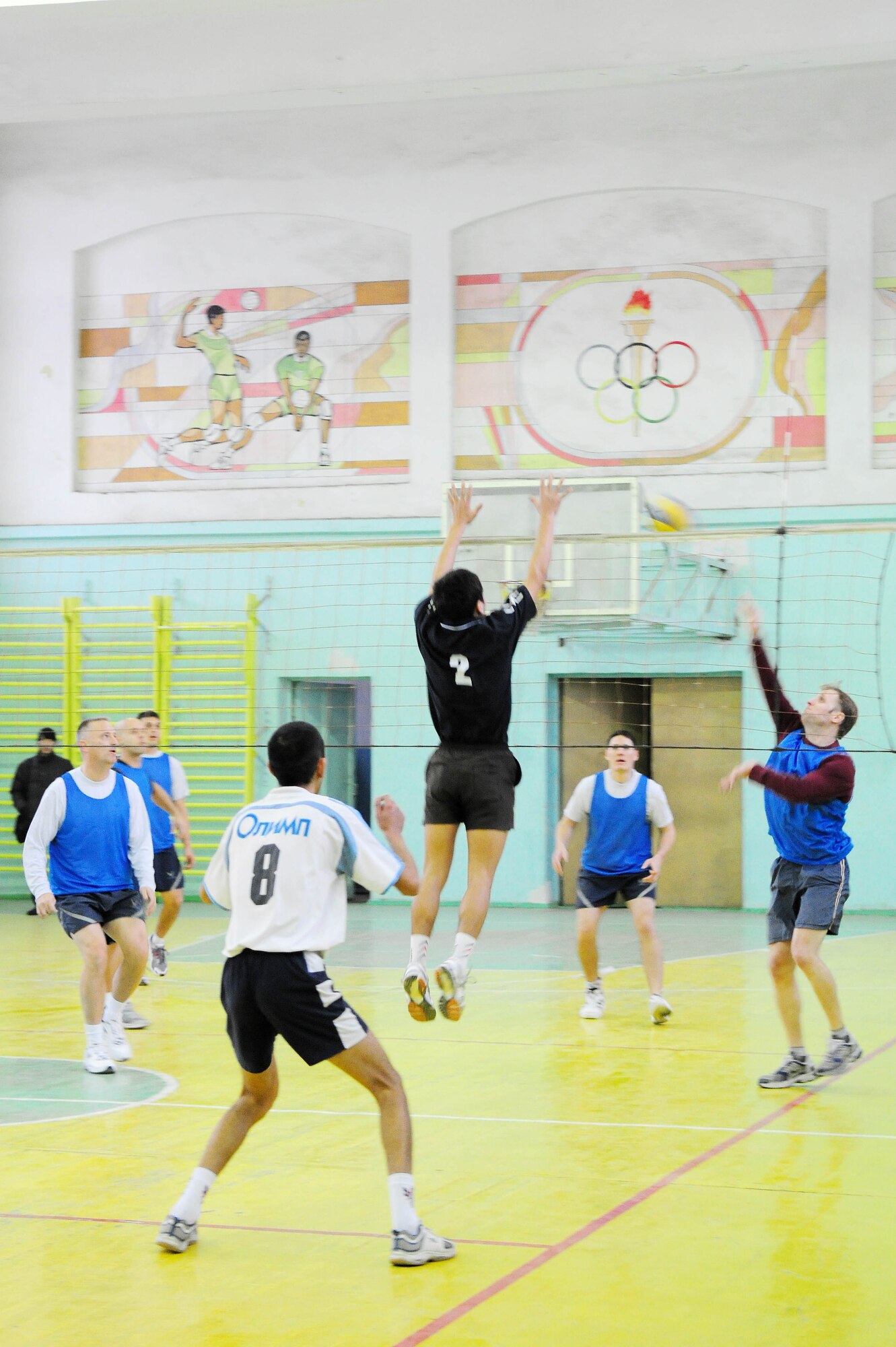 BISHKEK, Kyrgyzstan - The Kyrgyz Academy of Physical Culture and Sports volleyball team ramps up their defense against the Transit Center at Manas team during a friendly match here Jan. 8. The Kyrgyz team is comprised of full-time athletes, while the U.S. Air Force team is primarily made up military servicemembers. (U.S. Air Force photo by Senior Airman Nichelle Anderson)