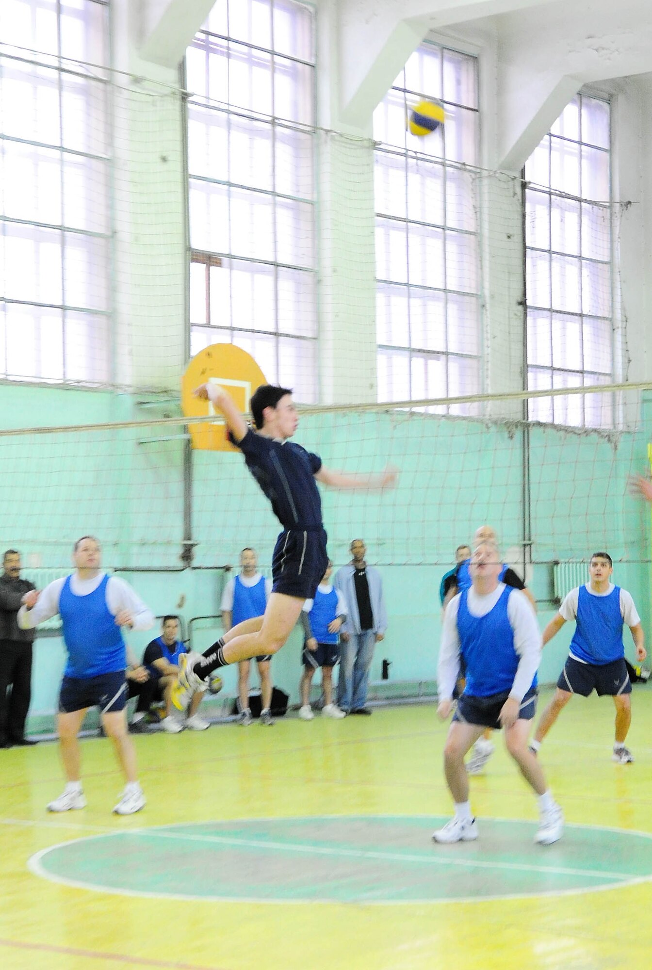 BISHKEK, Kyrgyzstan - An athlete from the Academy of Physical Culture and Sports fakes a spike during a friendly volleyball match against the Transit Center at Manas team Jan. 8. The Kyrgyz team is comprised of full-time athletes, while the TC team is primarily made up of military servicemembers. In spite of the American's loss, the friendly conduct between the two teams helped build a strong community bond. (U.S. Air Force photo by Senior Airman Nichelle Anderson)