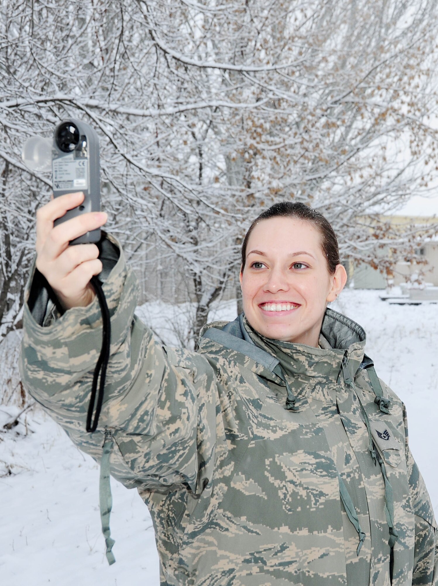 TRANSIT CENTER AT MANAS, Kyrgyzstan - Staff Sgt. Stephanie Meyers, 376th Expeditionary Operations Support Squadron weather technician, takes a tactical weather observation with a hand-held sensor system known as the Kestrel, which detects wind speeds, air pressure, temperature, and relative humidity. She also provides forecasts of Kyrgyzstan and Afghanistan for pilots prior to missions as well as resource protection by issuing weather watches, warnings, and advisories.  Sergeant Meyers is deployed from Altus Air Force Base, Okla. and hails from Pierre, S.D. (U.S. Air Force photo by Senior Airman Nichelle Anderson)
