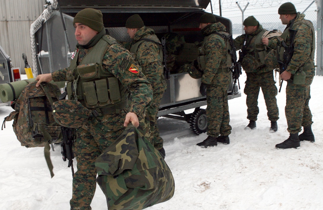 Soldiers from the Republic of Georgia Army's 31st Light Infantry Battalion gather their gear after arriving at the Nrnberg International Airport here. The Georgian battalion will be participating in a two-week mission readiness exercise for their upcoming deployment to Afghanistan in support of International Security Assistance Forces there. The exercise will take place at the Joint Multination Readiness Center in Hohenfels, Germany and feature multinational observer controllers and role players from the U.S. Marine Corps, U.S. Army, and Slovenian Army.