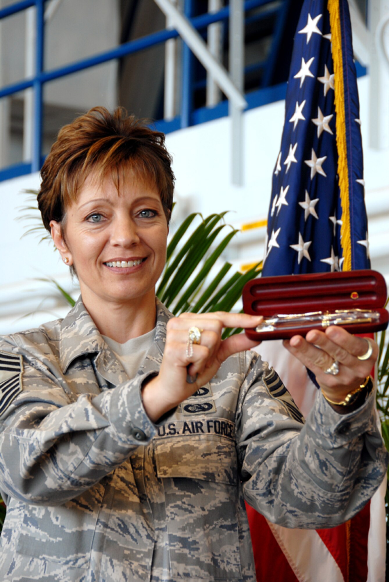 Command Chief Master Sgt. Jelinski-Hall displays gift given to each 
Airman honored during the Hometown Heroes ceremony held here Dec. 6. (U.S. Air Force photo by Tech. Sgt. Betty J. Squatrito-Martin)