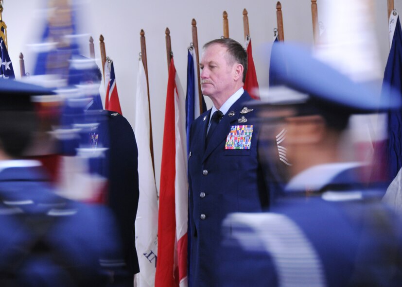 Chief Master Sgt. Lyle Spangler watches at attention as the Eglin Air Force Base honor guard brings in the flag for the National Anthem during his retirement ceremony at Duke Field, Jan. 9.  Chief Spangler began his 36-year career in 1973 and transitioned to the reserves in 1978.  The chief completed his career as a member of the 711th Special Operations Squadron.  U.S. Air Force photo by Tech. Sgt. Samuel King Jr.