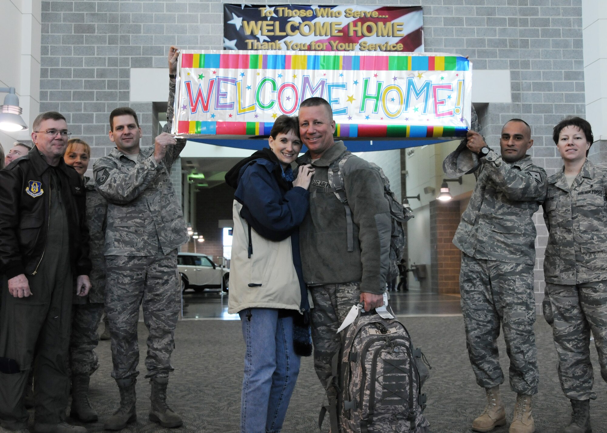 Master Sgt. Donald Peters, 919 Medical Squadron first sergeant, returned from a deployment to Balad, Iraq, to wife Yvonne and well wishers from the squadron, Jan. 9.  (U.S. Air Force photo by Tech. Sgt. Samuel King Jr.)