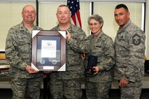 174th Fighter Wing Support Group Commander Col. Harvey M. Van Wie Jr., Lt. Col. Barbara J. Hisel and Senior Master Sgt. Gregory W. Giamas present Master Sgt. Alan P. Dobransky with the "Hometown Heroes" plaque. The plaque is given out to members of the Air National Guard who have deployed since the attacks on September 11th in support of Operations Enduring Freedom and Iraqi Freedom. (RELEASED)