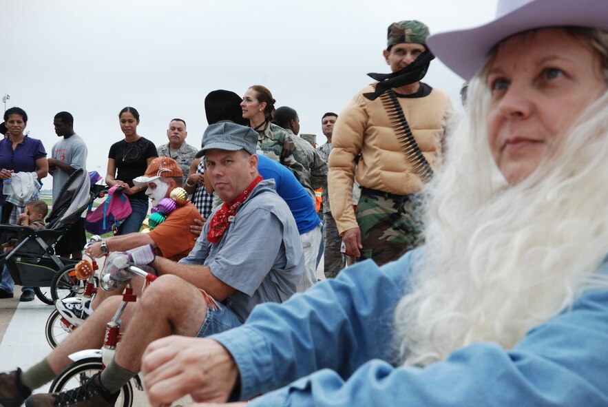 Family day during the combined October unit training assembly at the 433rd Airlift Wing, Lackland Air Force Base, Texas. The Alamo Wing holds Family Day to give something back the Reservists who serve as well as the families and friends who support the Reservists. Commanders and dupervisors dress in wild costumes for the tricycle race, which Lt. Col. David Scott, Operation Support Squadron won. (U.S. Air Force photo/Airman 1st Class Brian McGloin)