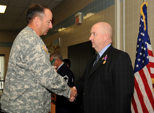 Maj. Gen. Brian L. Tarbet, The Adjutant General of the Utah National Guard, awards Brig. Gen. Scott Harrison the Joint Medal of Merit for his service during a retirement ceremony on January 9 at the Utah Air National Guard Base. General Harrison was the deputy commander of Joint Forces Headquarters, Utah NG, and officially retired from the Guard after 35 years.   U.S. Air Force Photo by: Staff Sgt. Emily Monson (RELEASED)