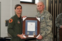 174th Fighter Wing Operations Group Commander Col. Greg A. Semmel presents Master Sgt. Jeffery A. Gagnon with the "Hometown Heroes" plaque. The plaque is given out to members of the Air National Guard who have deployed since the attacks on September 11th in support of Operations Enduring Freedom and Iraqi Freedom. (RELEASED). 
