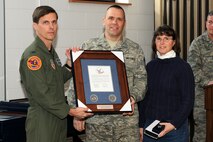 174th Fighter Wing Operations Group Commander Col. Greg A. Semmel presents Chief Master Sgt. James B. Boswell and his wife with the "Hometown Heroes" plaque. The plaque is given out to members of the Air National Guard who have deployed since the attacks on September 11th in support of Operations Enduring Freedom and Iraqi Freedom. (RELEASED)