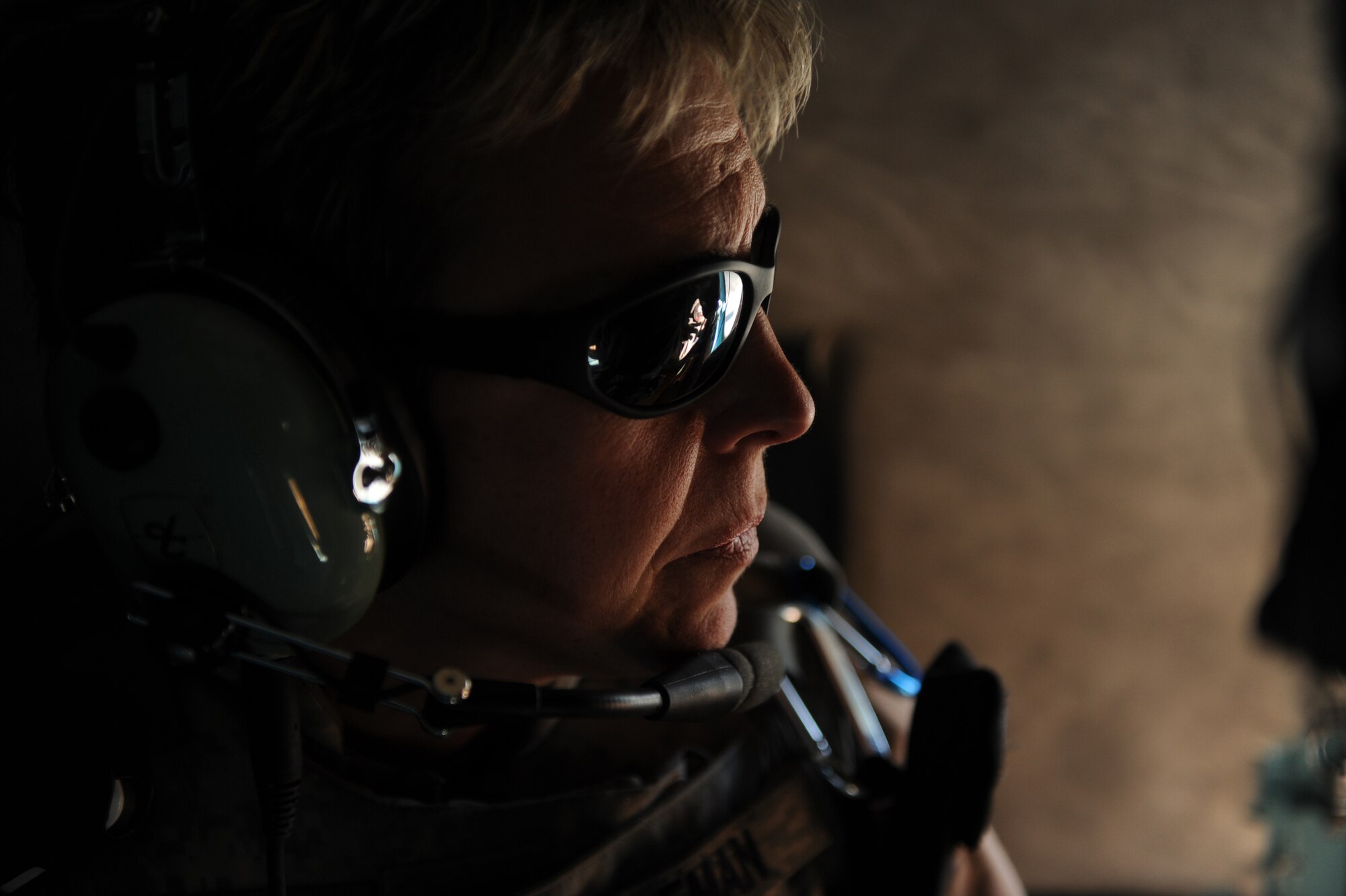 Maj. Kimberley Coleman, 441st Air Expeditionary Advisory Squadron (AEAS) flight nurse, looks out the window of an MI-17 piloted by a 441st Air Expeditionary Advisory pilot and Afghanistan National Army Air Corp pilots, Jan. 7, 2010, in Southern, Afghanistan. Afghanistan National Army Air Corps Soldiers delivered 30 passengers (ANAAC Soldiers) and one pallet of cargo destined for 82nd Airborne Soldiers with the 508th Parachute Infantry Regiment at Forward Operating Base Tarin Kowt.  (U.S. Air Force photo/Staff Sgt. Manuel J. Martinez)