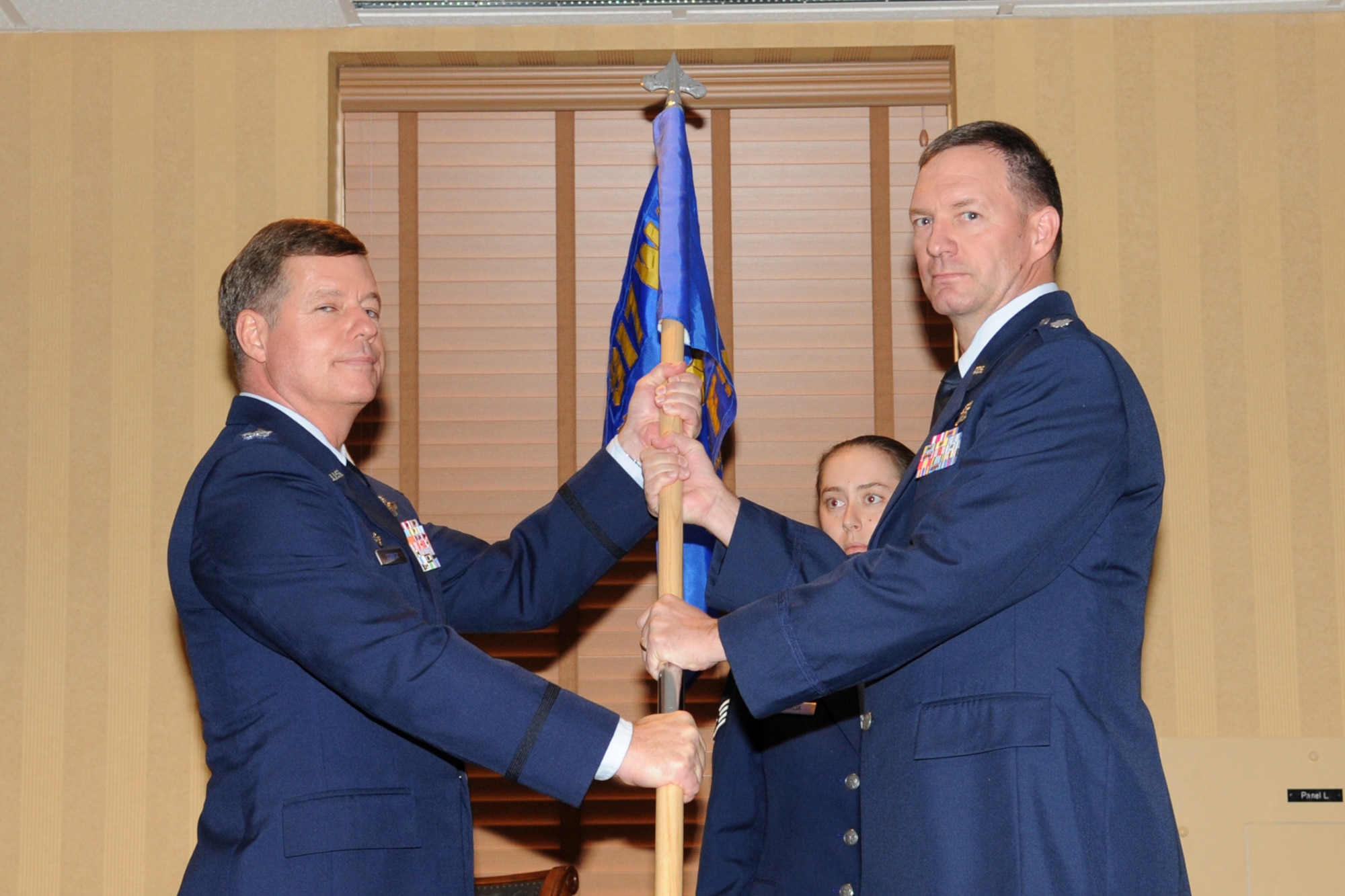Col. Keith Schultz, 917th Operations Group deputy commander at Barksdale Air Force Base, hands the 45th Fighter Squadron’s guidon to Lt. Col. Terry McClain, commander of the 45th Fighter Squadron at Davis-Monthan Air Force Base, Ariz., during the reactivation ceremony for the 45thFS Jan. 7. Col. Schultz was the official presiding over the ceremony. The reactivation of this historic unit, by order of the Secretary of the Air Force Mr. Michael B. Donley, puts the 45th FS under the command of the 917th Wing Operations Group. (U.S. Air Force photo/Airman Jerilyn Quintanilla)